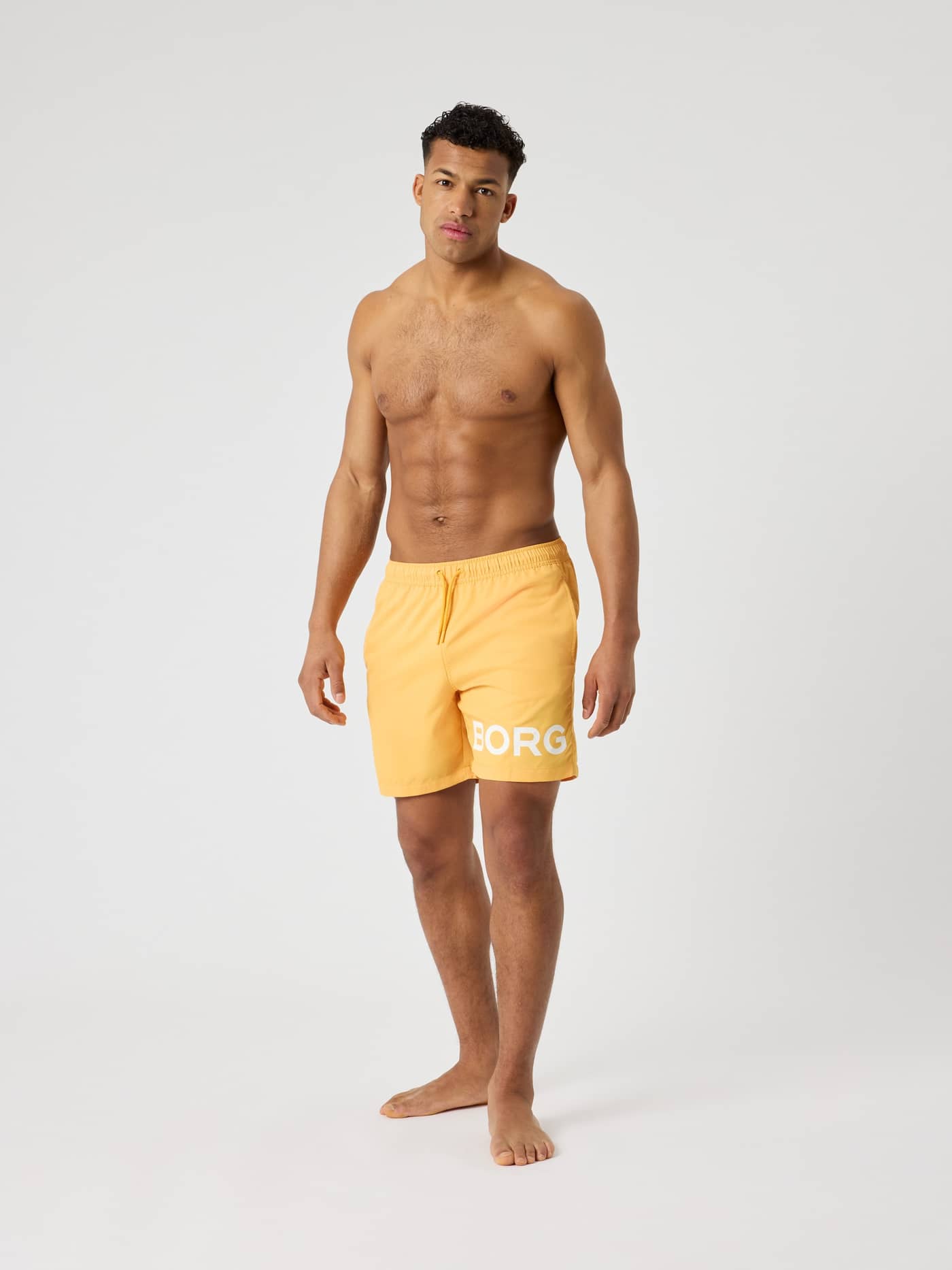 Borg Swim Shorts in Marigold (Gelb) mit weißem Logo aus schnelltrocknendem Material in der Ganzkörper-Frontansicht. - Image 3
