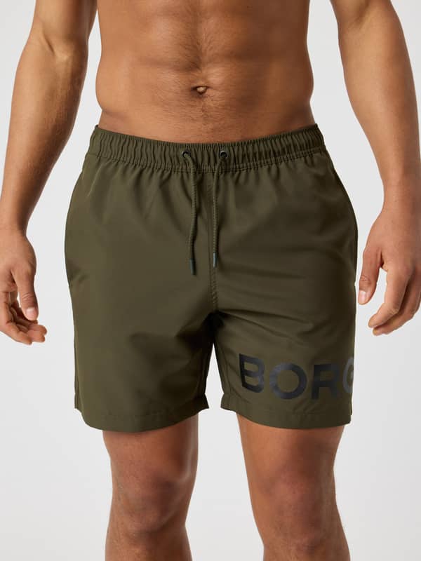 Front view of the quick-drying Borg Swim Shorts in Forest Night (Green) featuring a bold black logo on the leg.