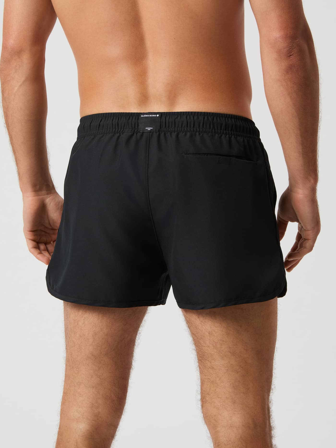 Back view of a man wearing the Björn Borg Retro Swim Shorts in Black Beauty (Black) with a stylish and functional slim fit. - Image 3