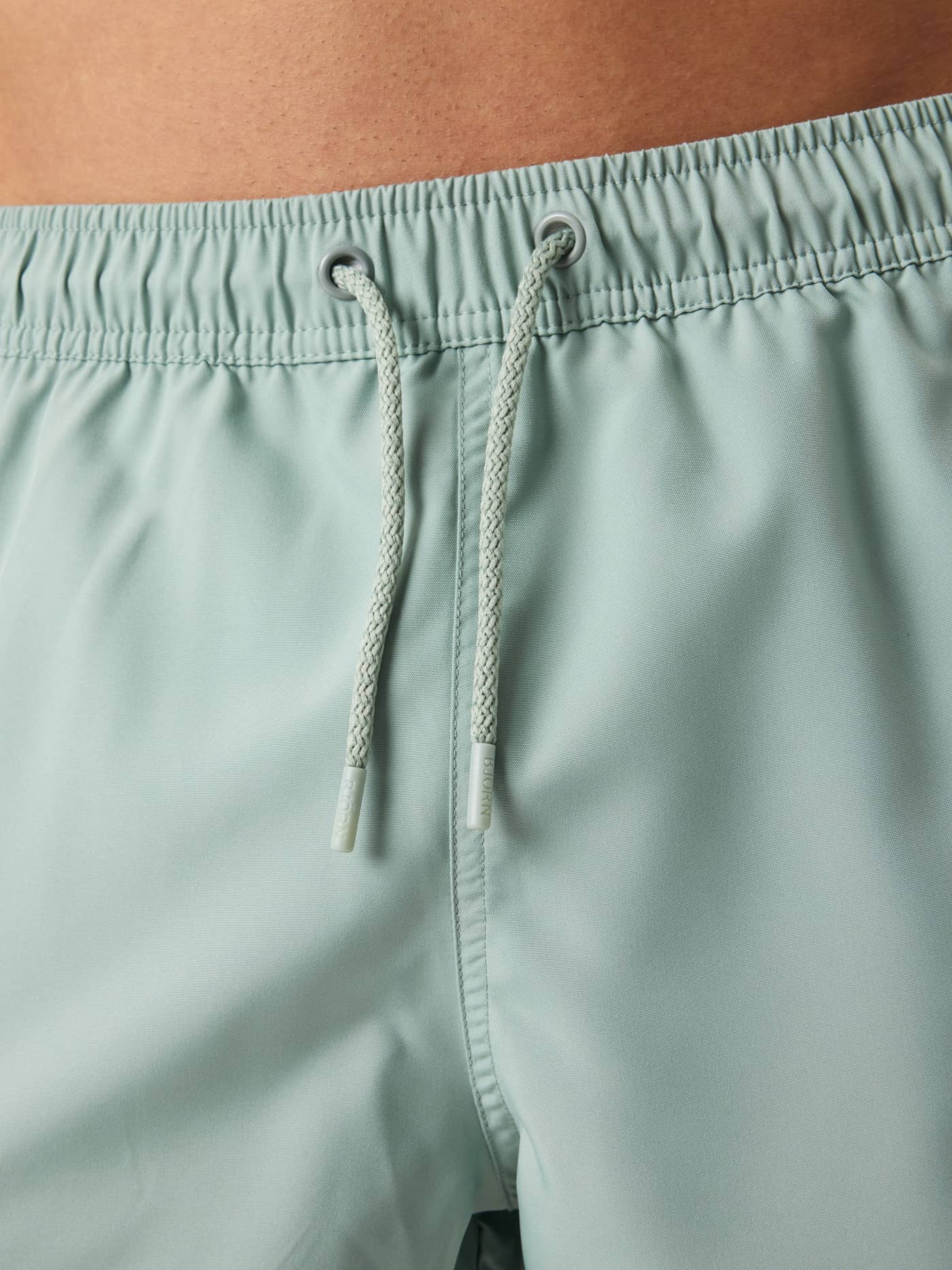 Functional drawstring and elastic waistband on the men's Björn Borg Solid Swim Shorts in Slate Gray (Green). - Image 5
