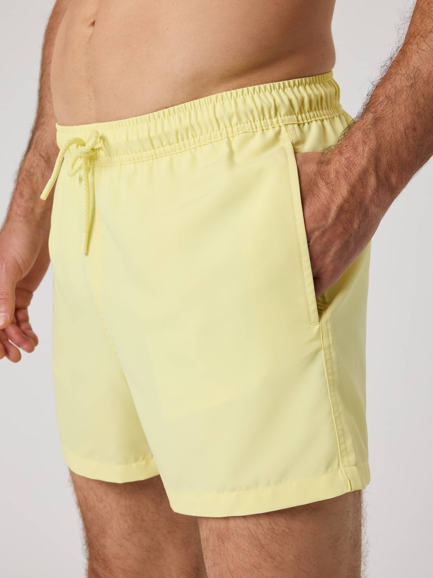 Björn Borg Solid Swim Shorts in Lemonade (Yellow), shown in a close-up side view with a drawstring and side pocket. - Image 5