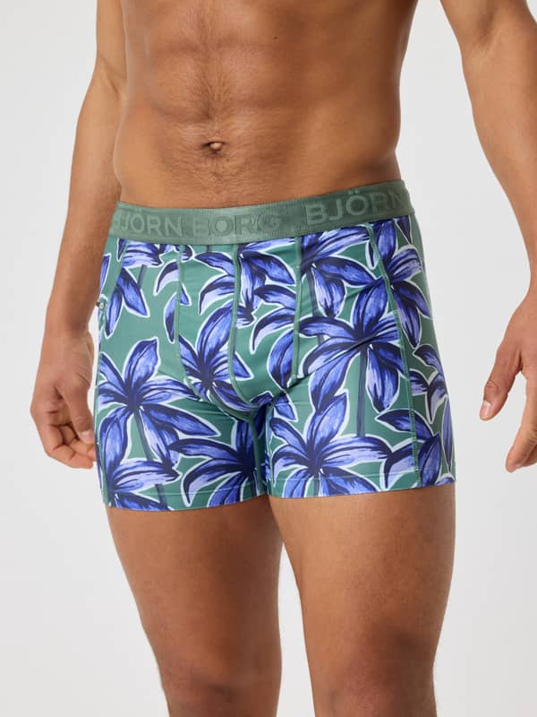 Borg Stretch Swim Shorts i Palms On Palms 1 (Blå/Grøn) set forfra med palmemotiv og grøn logo-linning.