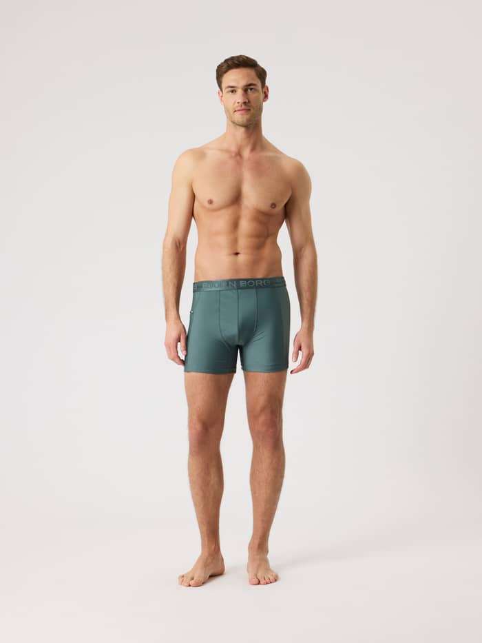 Borg Stretch Swim Shorts in Balsam Green (Groen) met een slanke pasvorm en logo-tailleband in vooraanzicht.