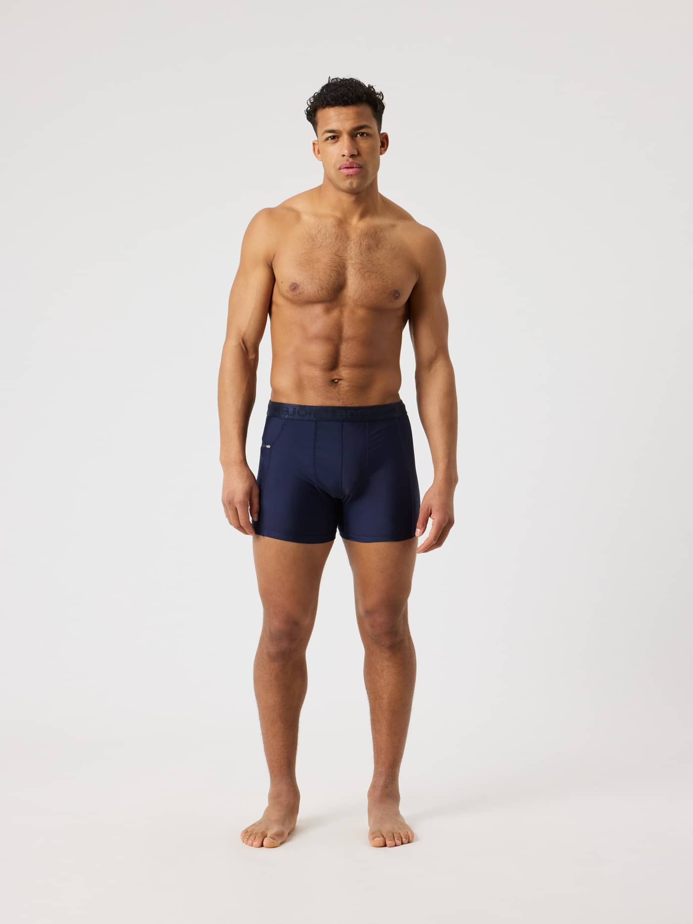 Full-body front view of a man wearing the Björn Borg Stretch Swim Shorts in Night sky (Navy), with a slim, supportive fit. - Image 3