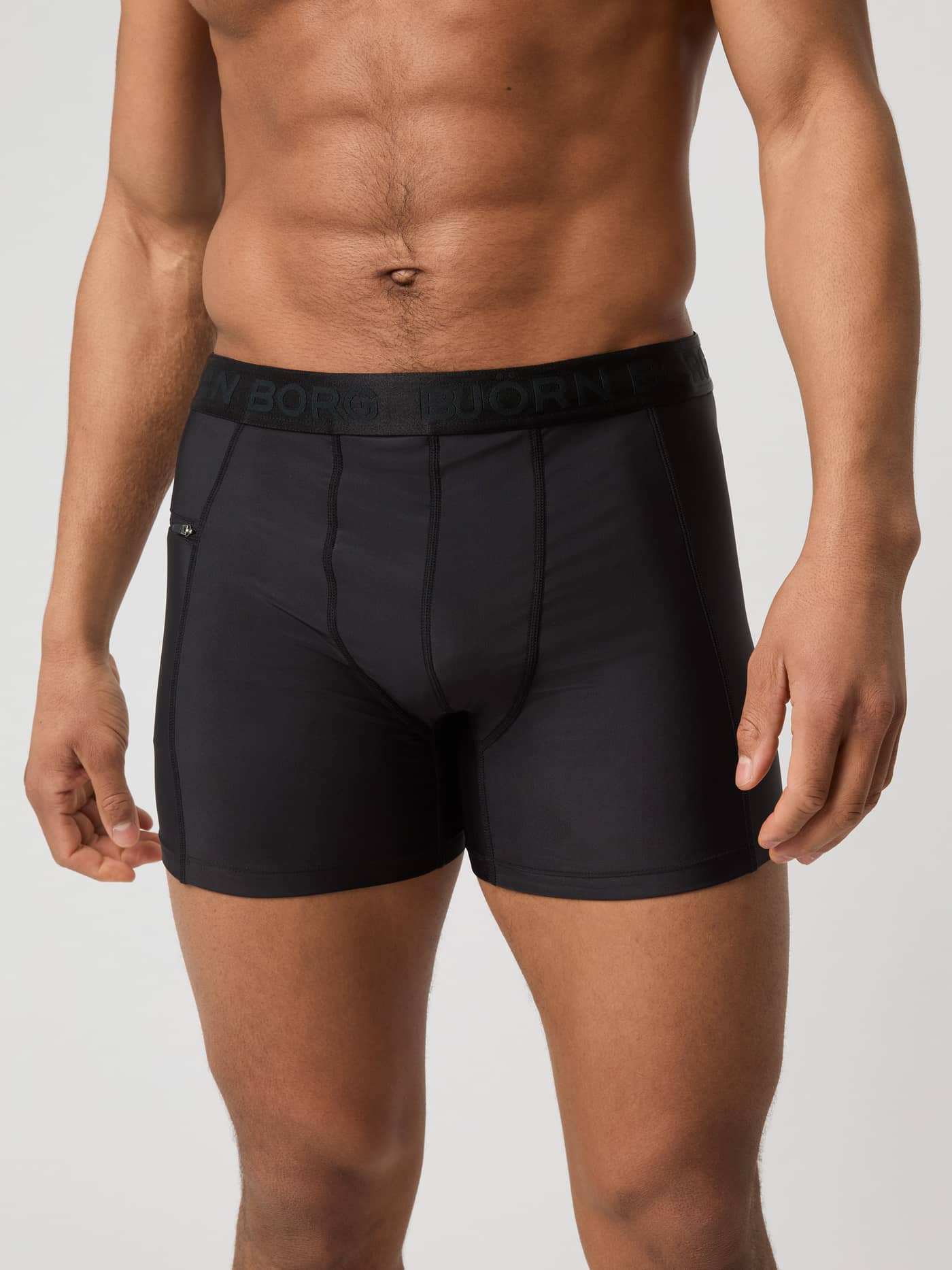 Front view of a man wearing the slim-fit Björn Borg Stretch Swim Shorts in Black Beauty (Black). - Image 2