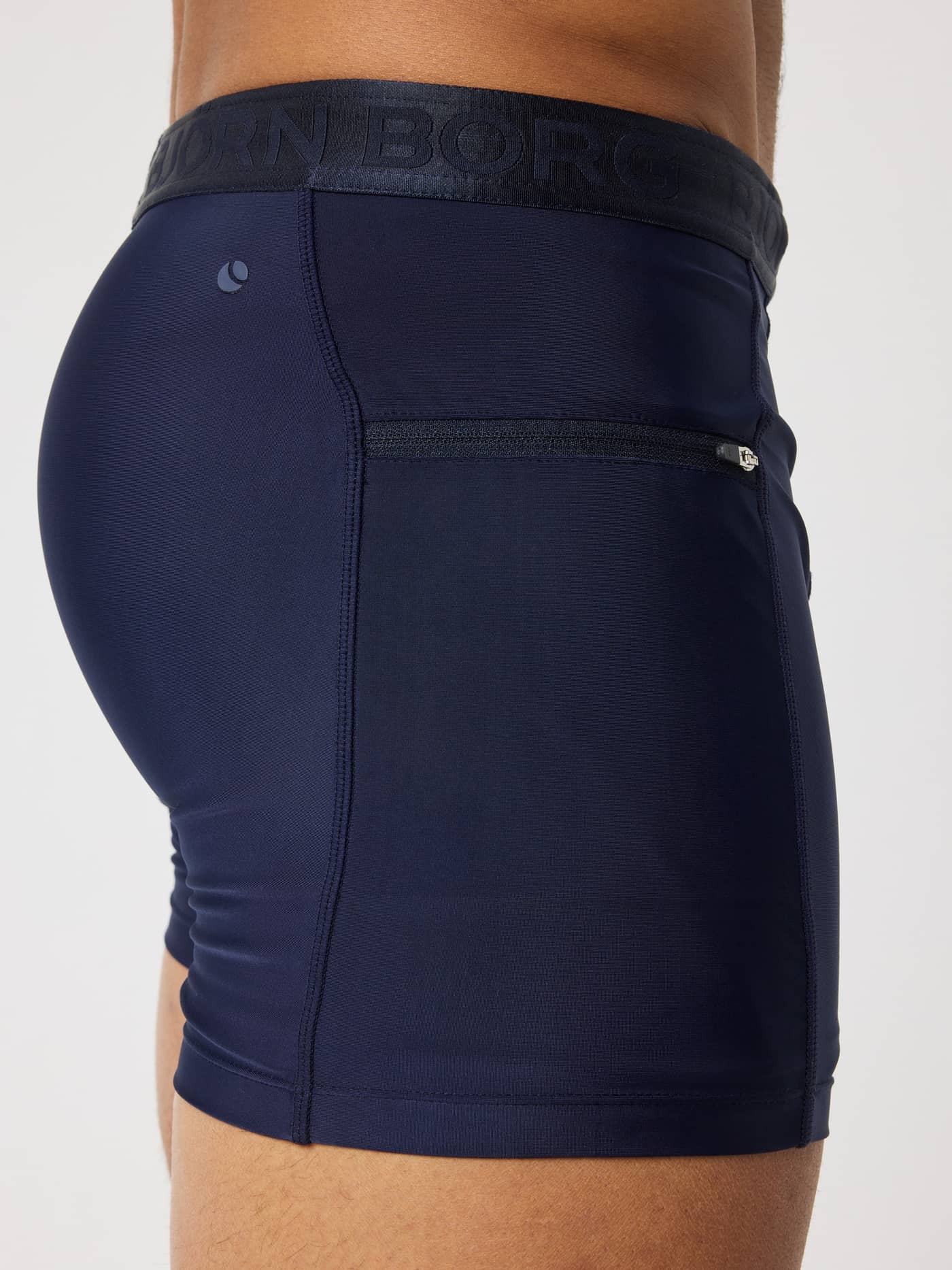 Side view of the quick-dry Björn Borg Stretch Swim Shorts in Night sky (Navy) featuring a side zipper pocket and tennis logo. - Image 4