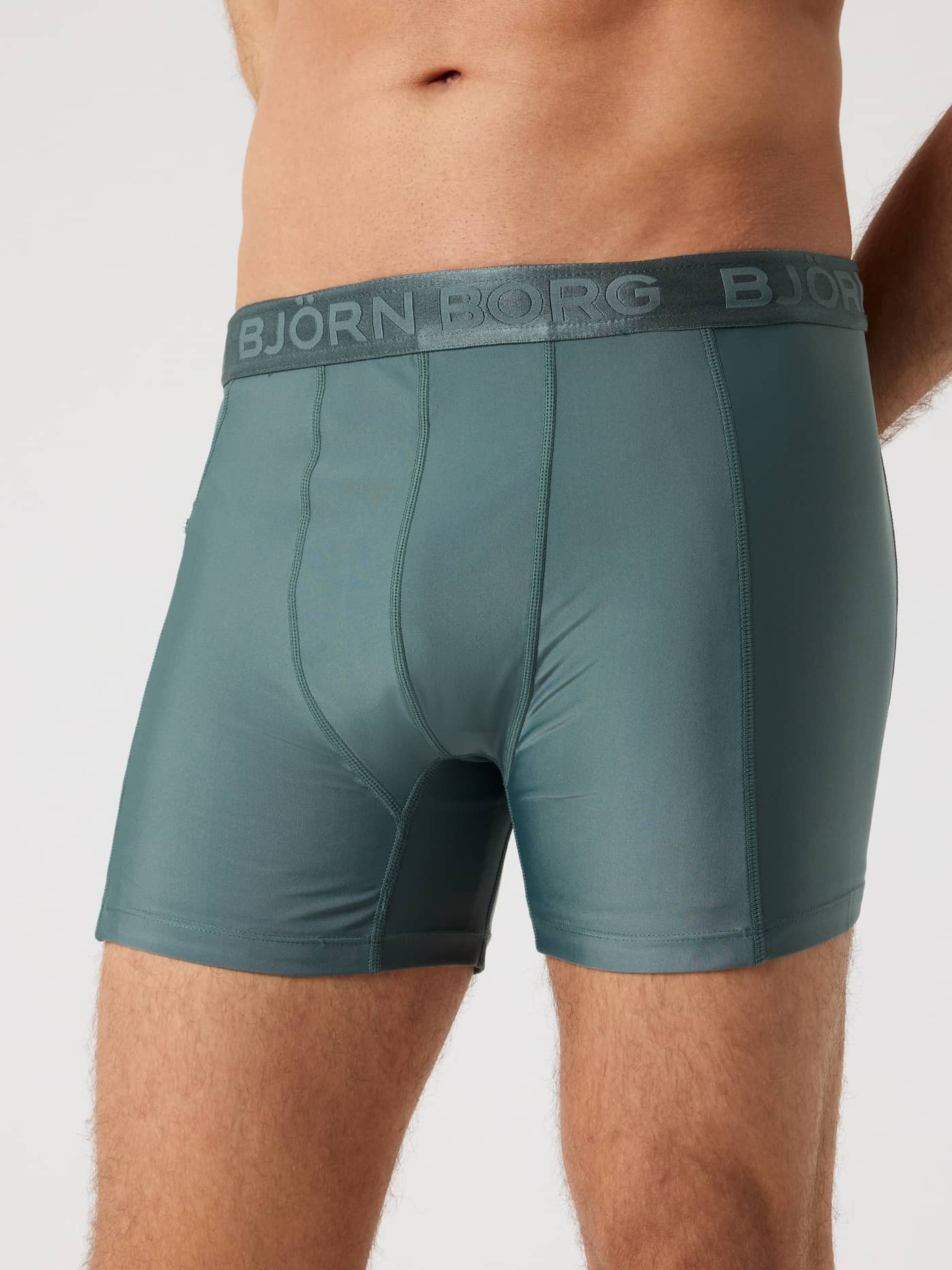 Front view of the slim-fit Björn Borg Stretch Swim Shorts in Balsam Green (Green) featuring tennis details. - Image 2