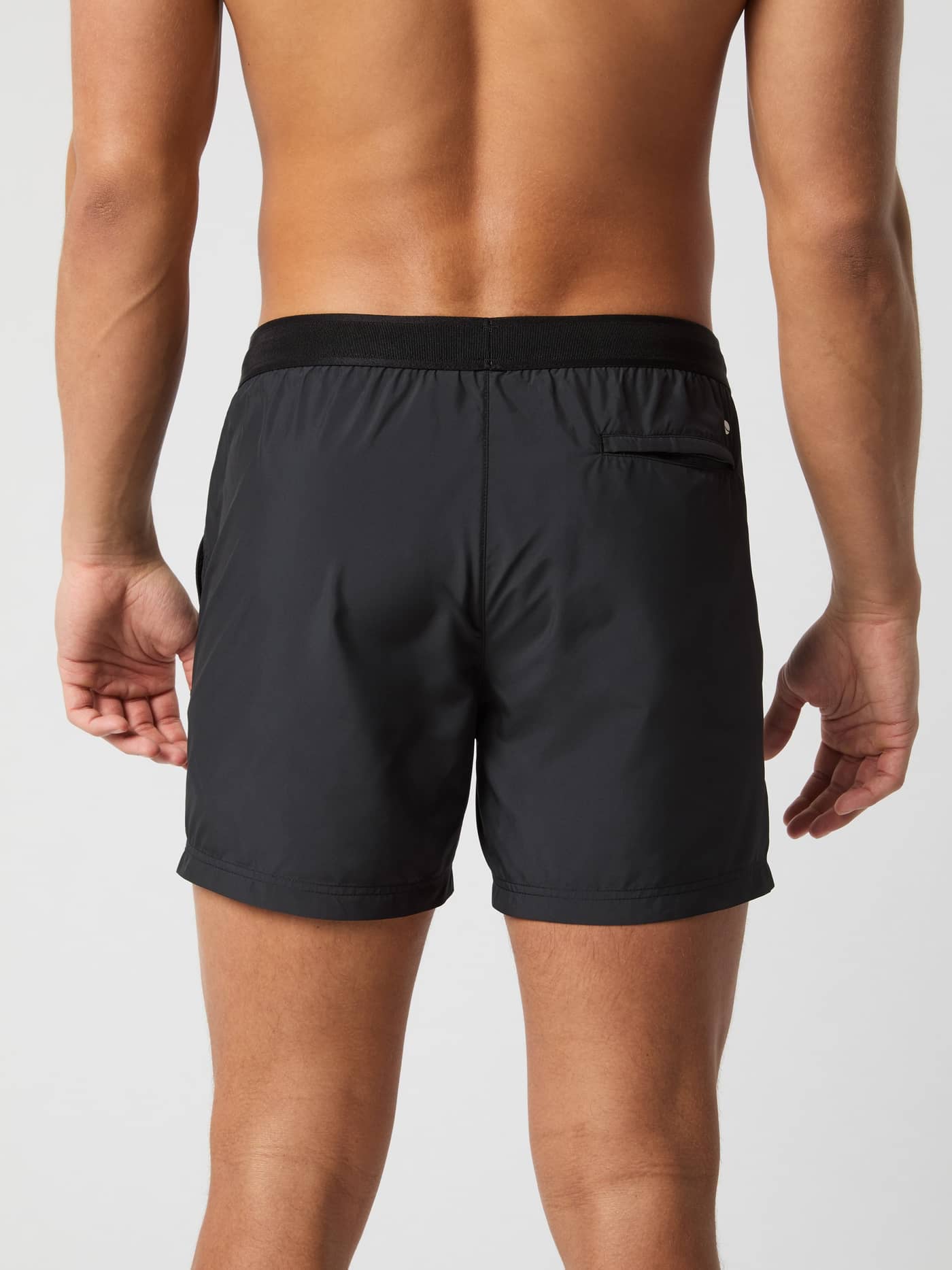Back view of a model wearing the Björn Borg Premium Swim Shorts in Black Beauty (Black) with a Velcro back pocket. - Image 3