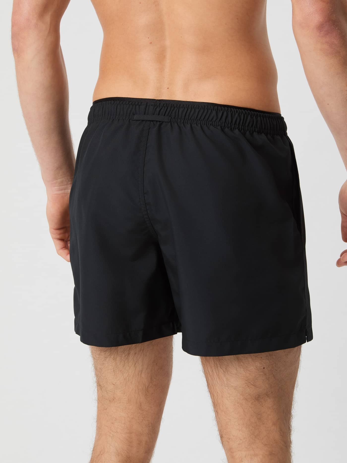 Back view of a man in stylish, functional Borg Elastic Swim Shorts in Black Beauty (Black) made from recycled polyester. - Image 3