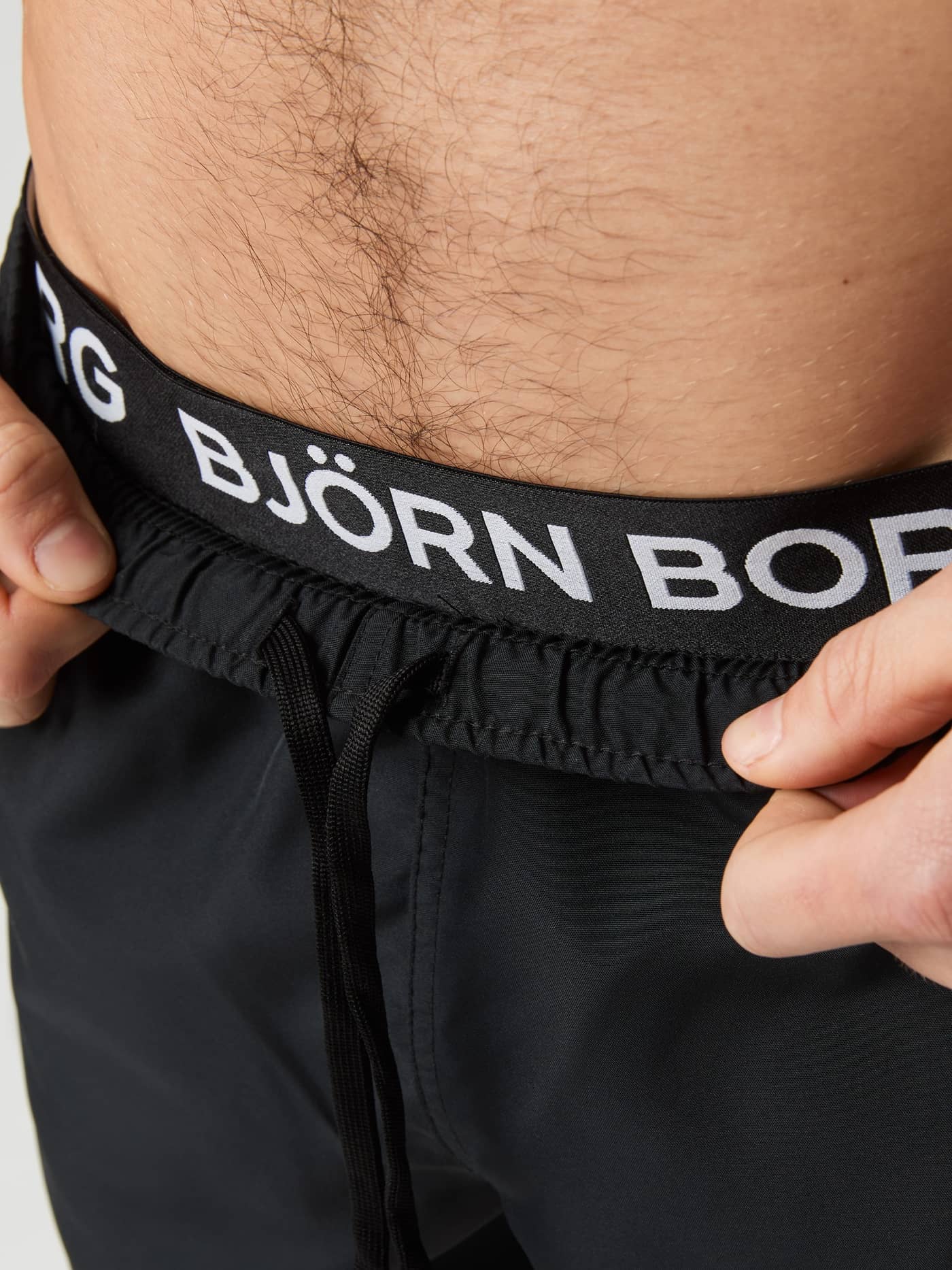 Close-up of the logo waistband and drawstring on the Borg Elastic Swim Shorts in Black Beauty (Black). - Image 4