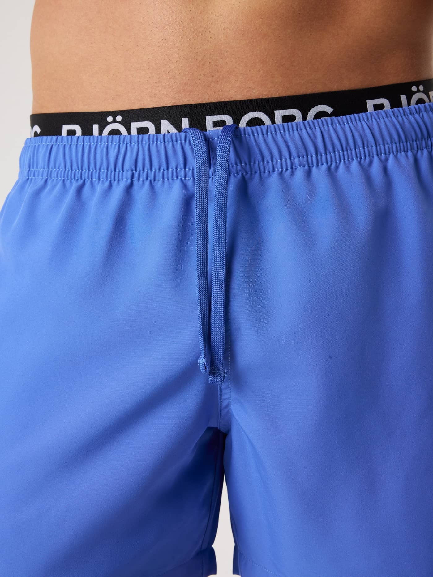 Close-up of the men's Borg Elastic Swim Shorts in Amparo Blue (Blue) with a branded waistband and adjustable drawstring. - Image 5