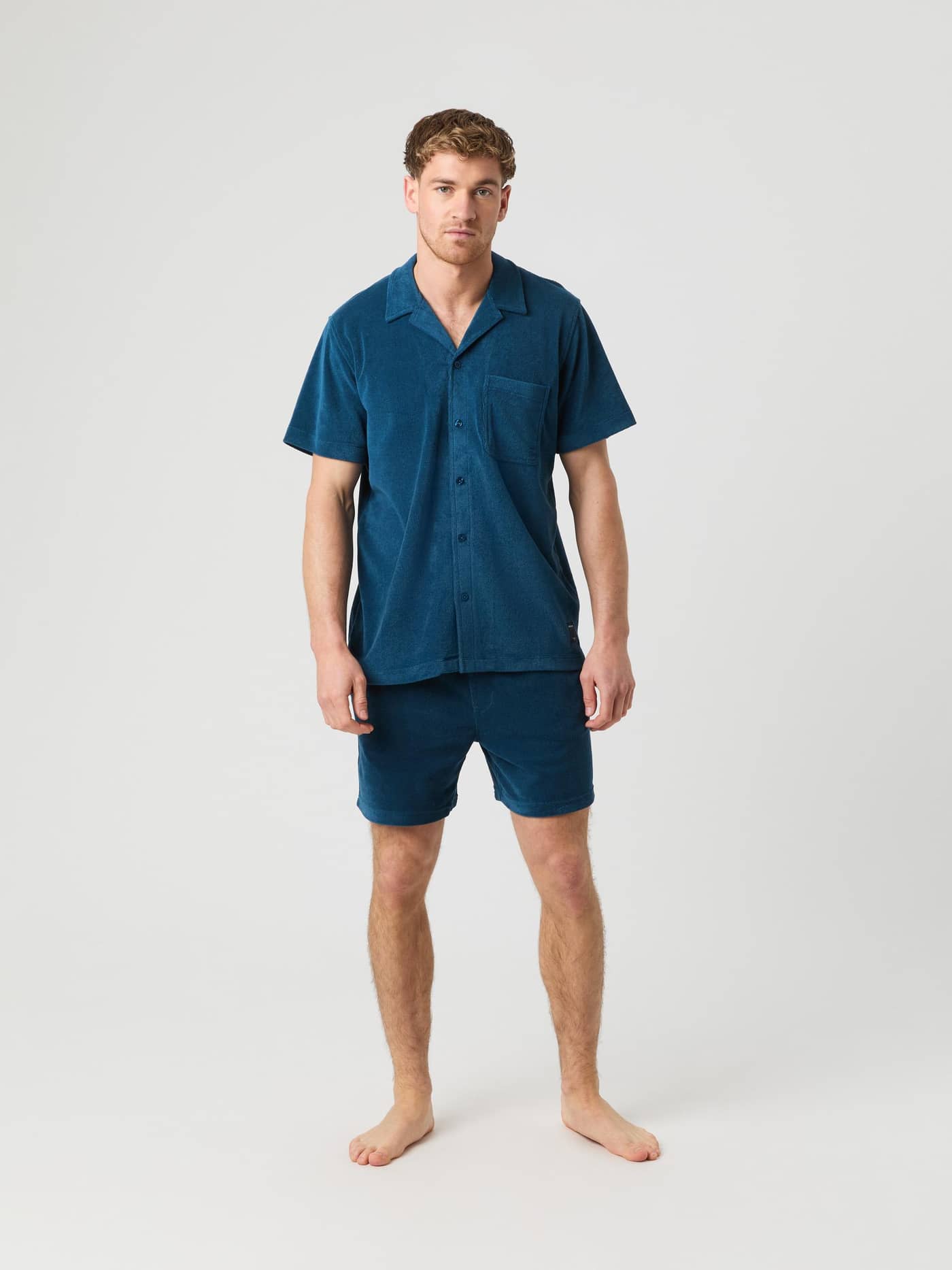 Full-body front view of a man wearing the Gibraltar Sea (Blue) Borg Toweling Pool Shirt in a soft toweling fabric. - Image 2