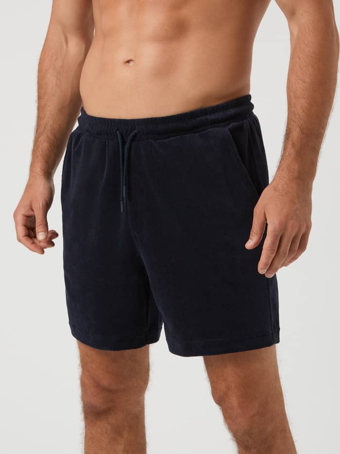 Front view of a man wearing the Borg Toweling Pool Shorts in Night Sky (Navy), featuring soft, functional toweling fabric.