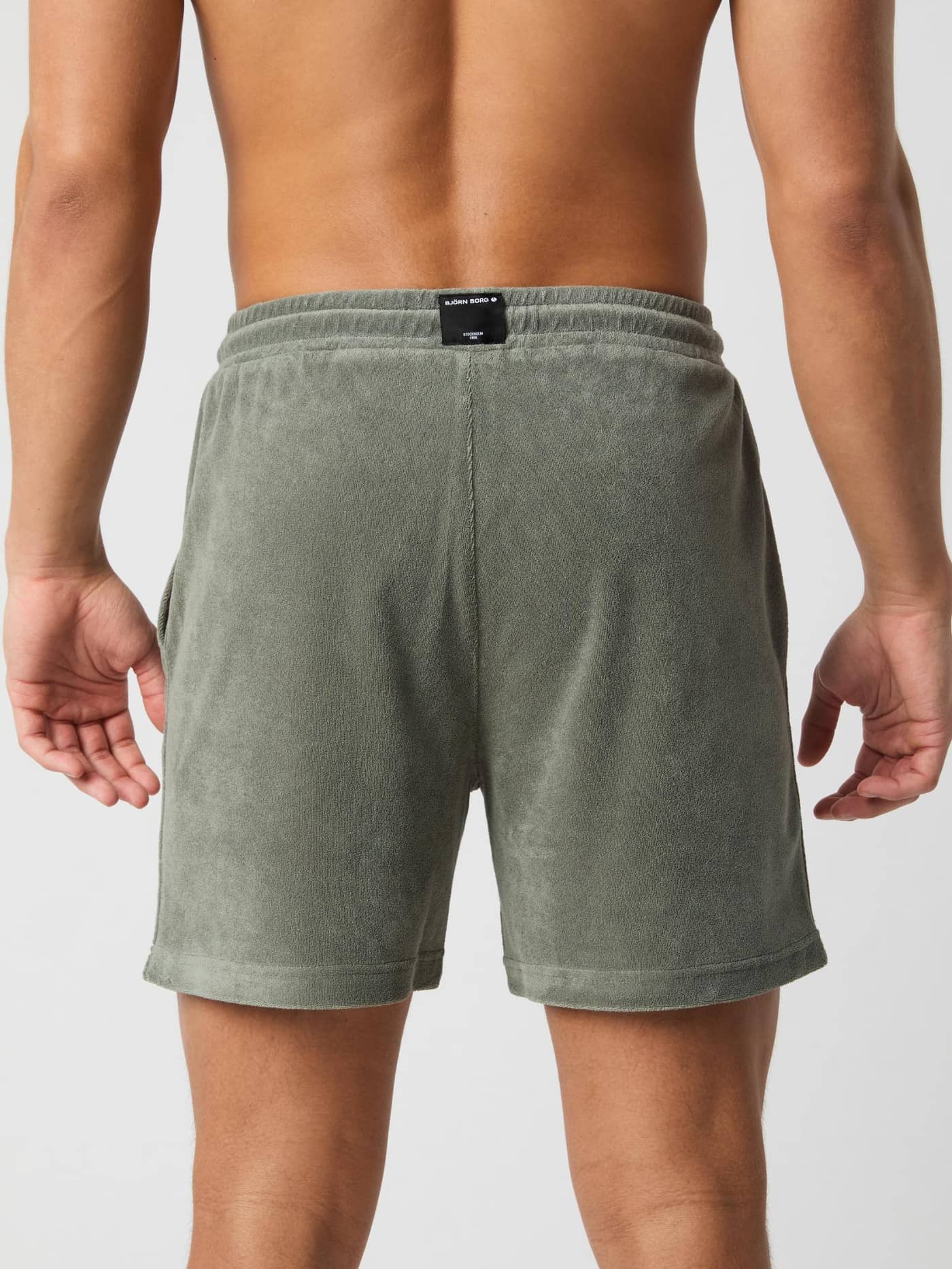 Back view of a man wearing Borg Toweling Pool Shorts in Agave Green (Green) featuring a soft toweling fabric and regular fit. - Image 3