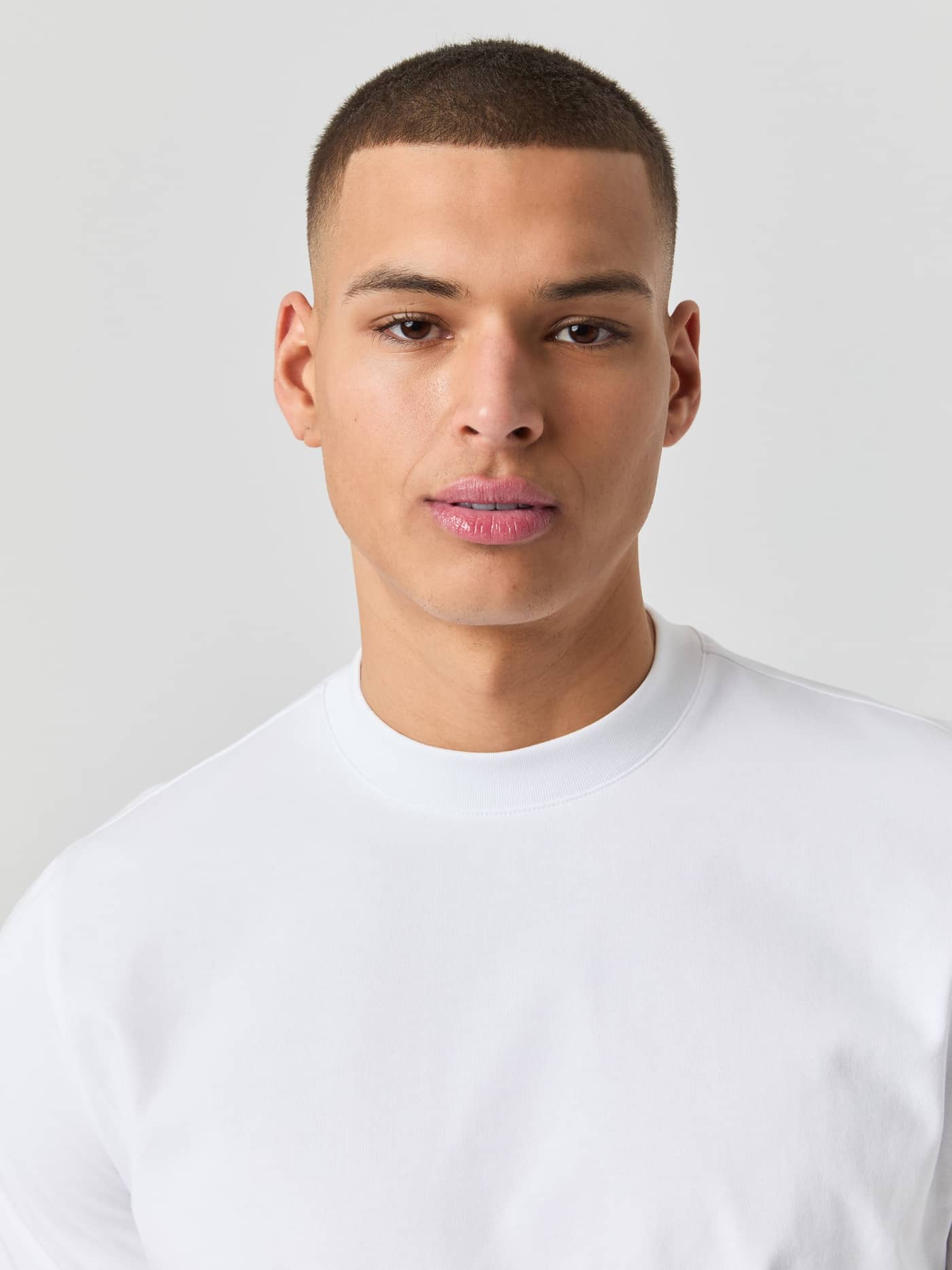 Nahaufnahme eines Mannes im Björn Borg Centre High Neck T-Shirt in Brilliant White (Weiß) mit funktionellem Mock Neck. - Image 4