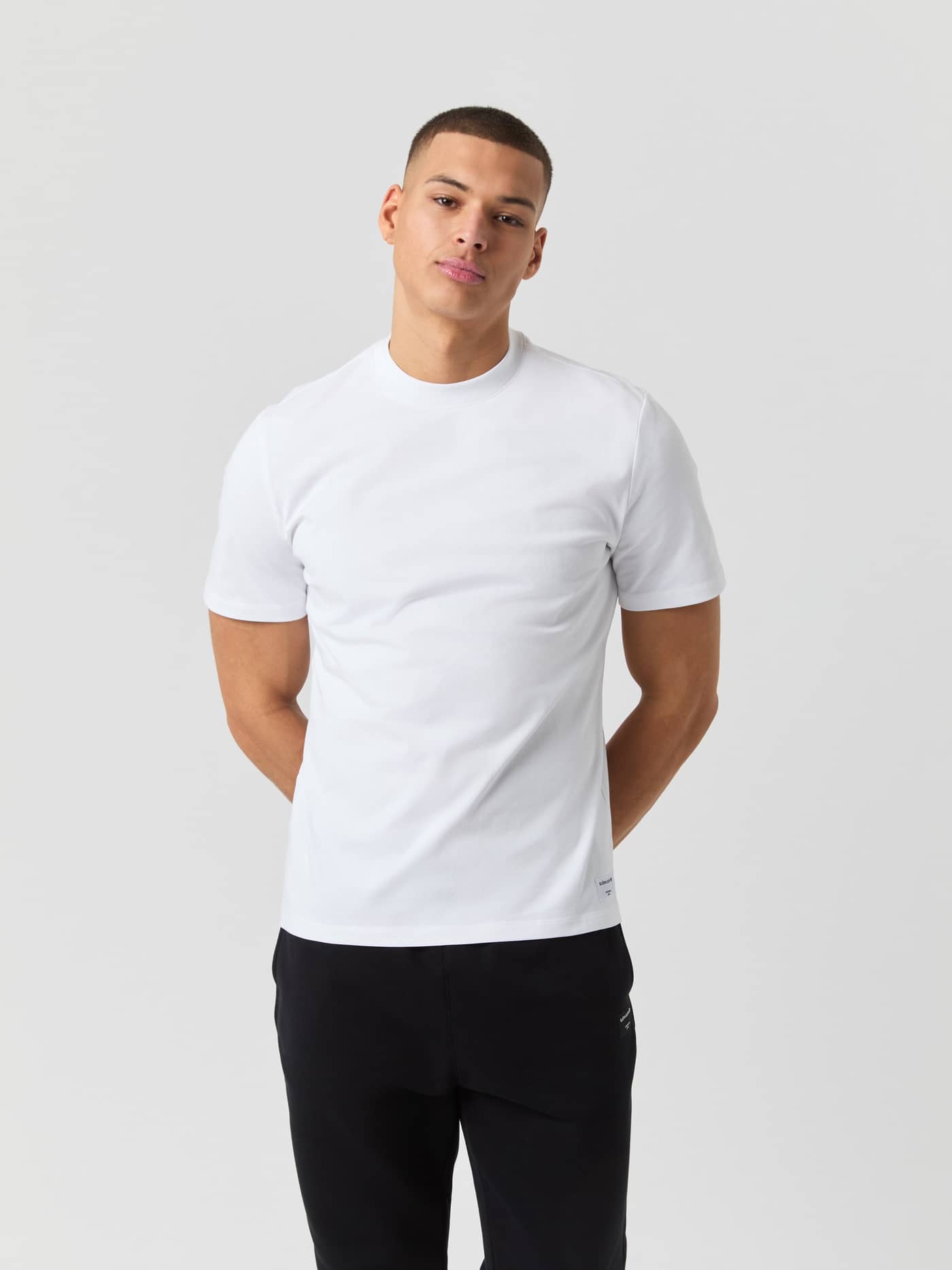 Vorderansicht eines Mannes im Björn Borg Centre High Neck T-Shirt in Brilliant White (Weiß) mit Oversized-Passform. - Image 1
