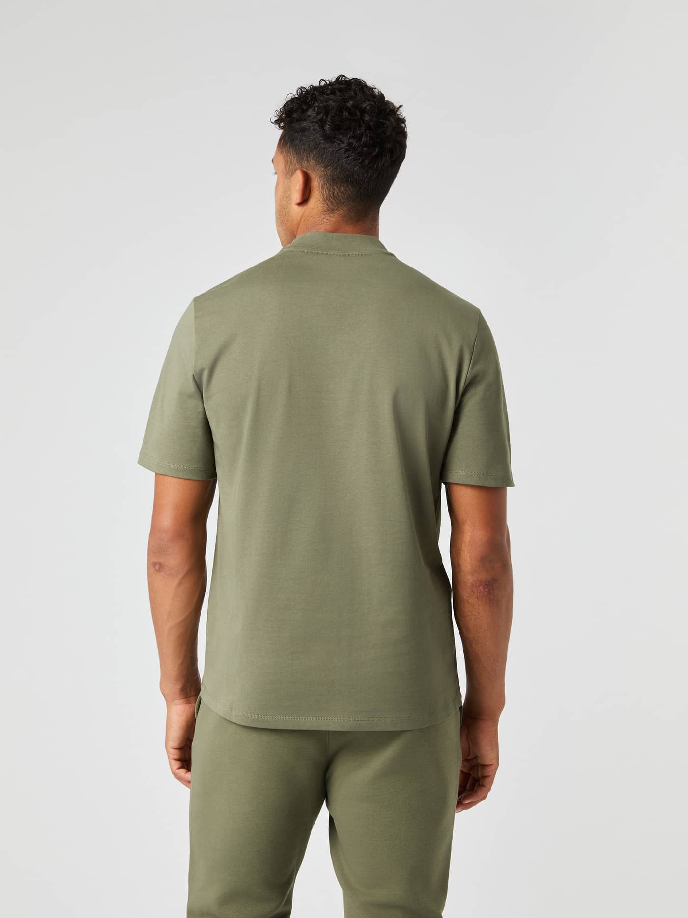 Back view of a man wearing the Björn Borg Centre High Neck T-Shirt in Dusty Olive (Green), featuring an oversized fit. - Image 3