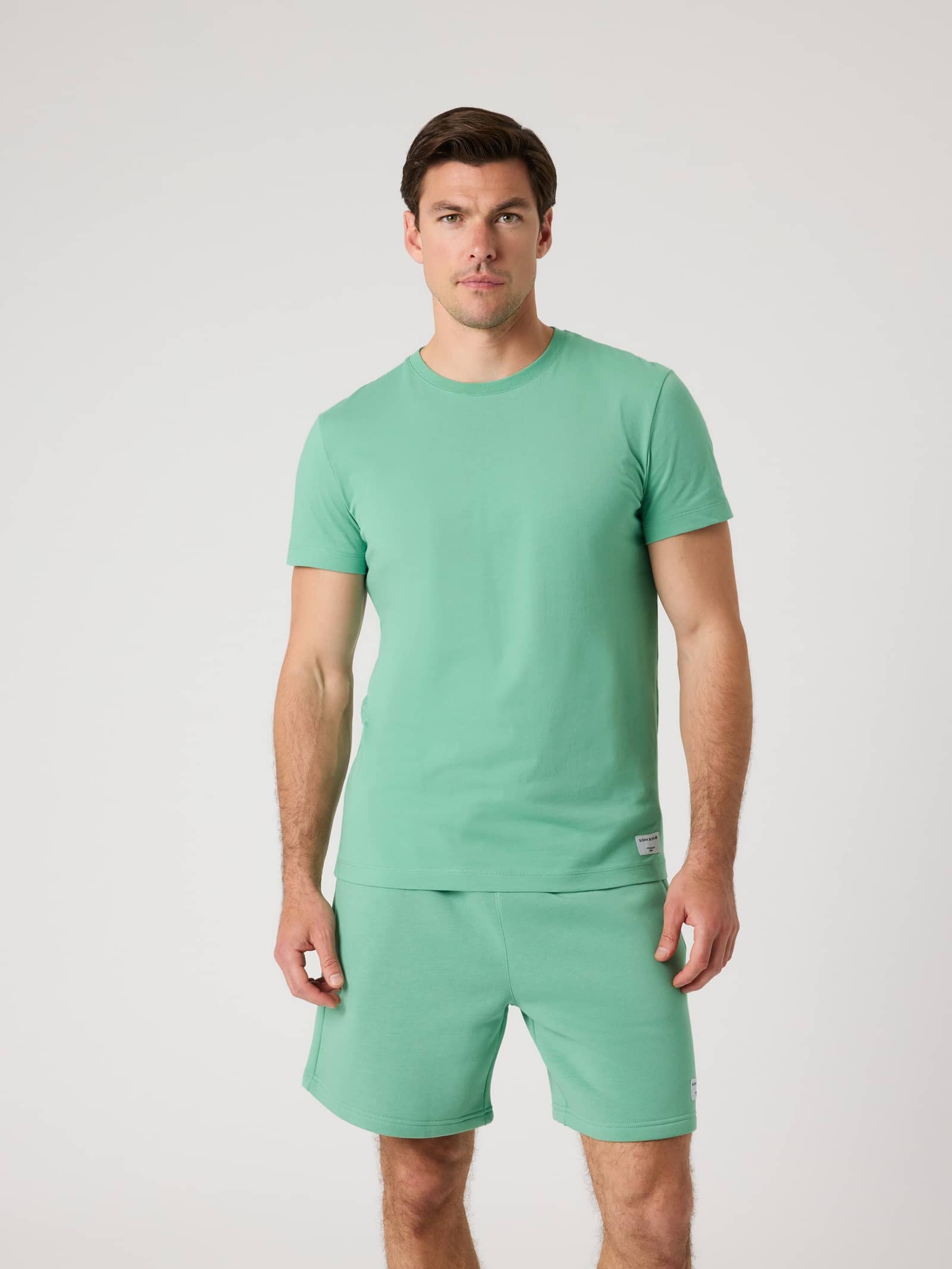 Front view of a man in the Malachite Green (Green) Björn Borg Centre High Neck T-Shirt in 100% cotton with an oversized fit. - Image 1