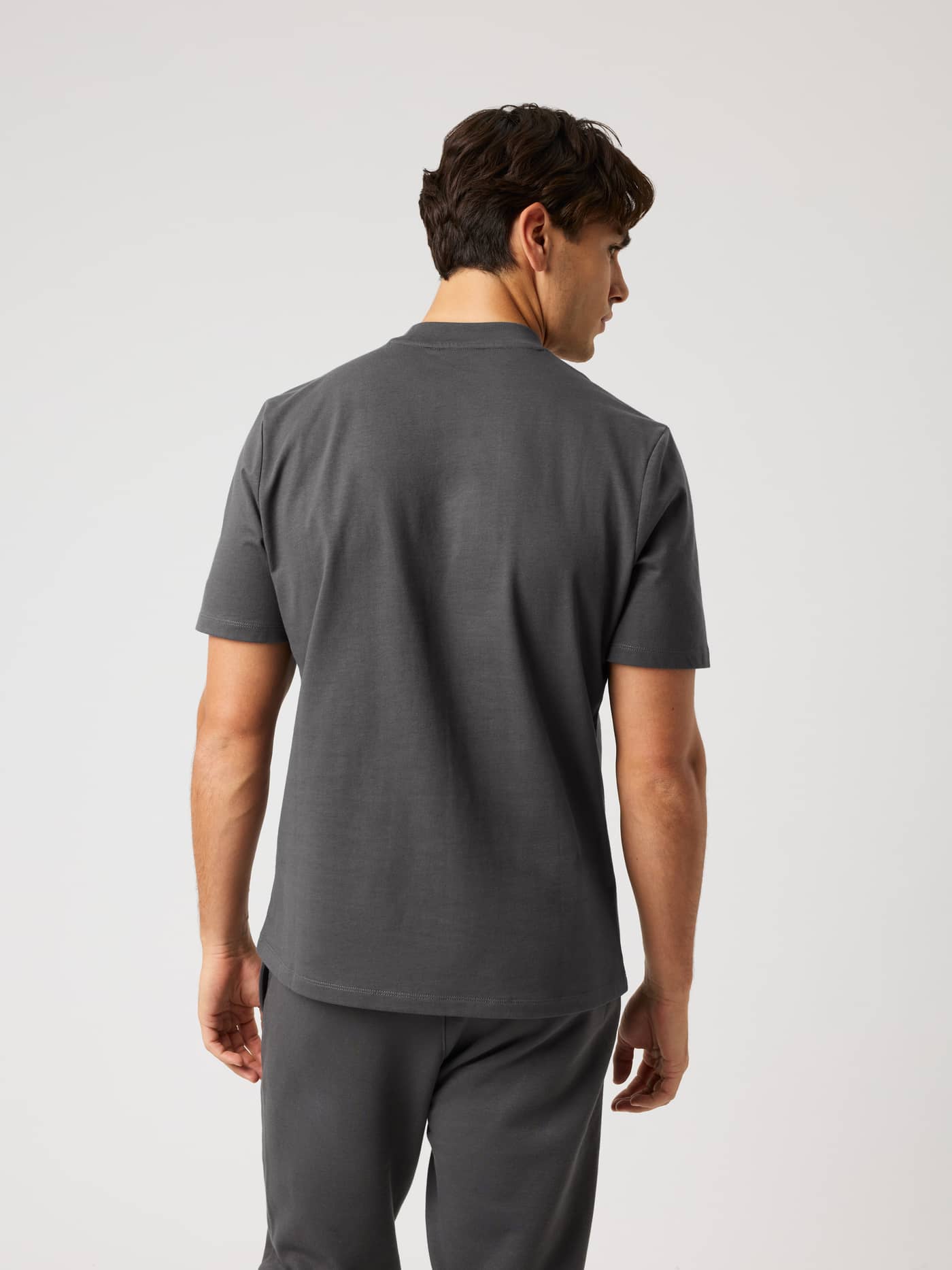 Back view of a model wearing the Björn Borg Centre High Neck T-Shirt in Asphalt (Grey) with a modern, oversized fit. - Image 2
