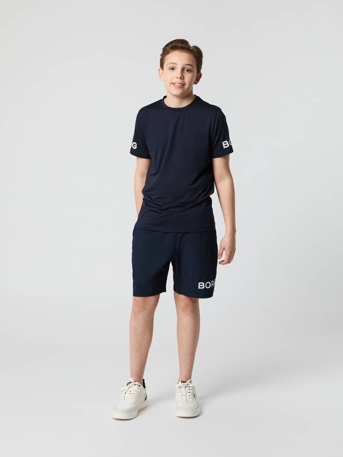 Full-body front view of a boy wearing the Björn Borg Borg Shorts in Night sky (Navy) for kids' training.