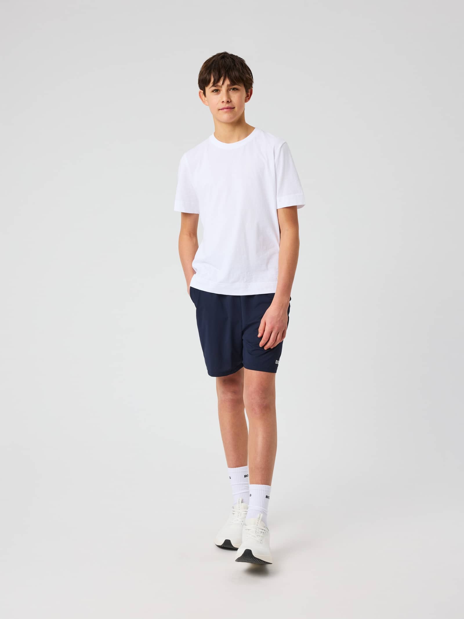 Full-body front view of a kid in the Björn Borg Soft Shorts in Night Sky (Navy) for style and training performance. - Image 1