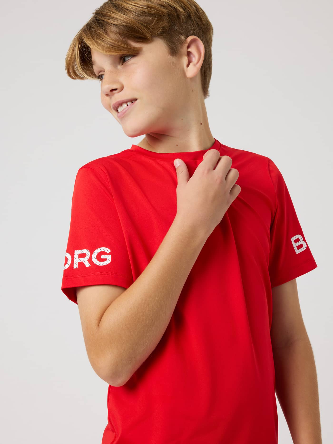 Kids Borg T-Shirt in Flame Scarlet (Red) for training, featuring white logo prints on the short sleeves. - Image 4