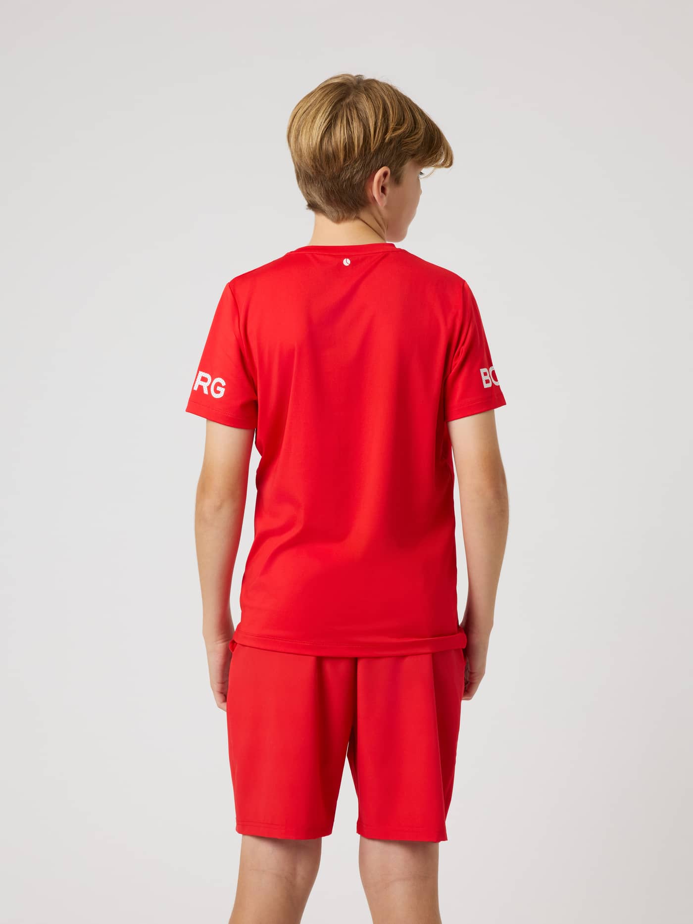 Back view of a kids' Borg T-Shirt in Flame Scarlet (Red) with white sleeve logos, perfect for tennis and training. - Image 2