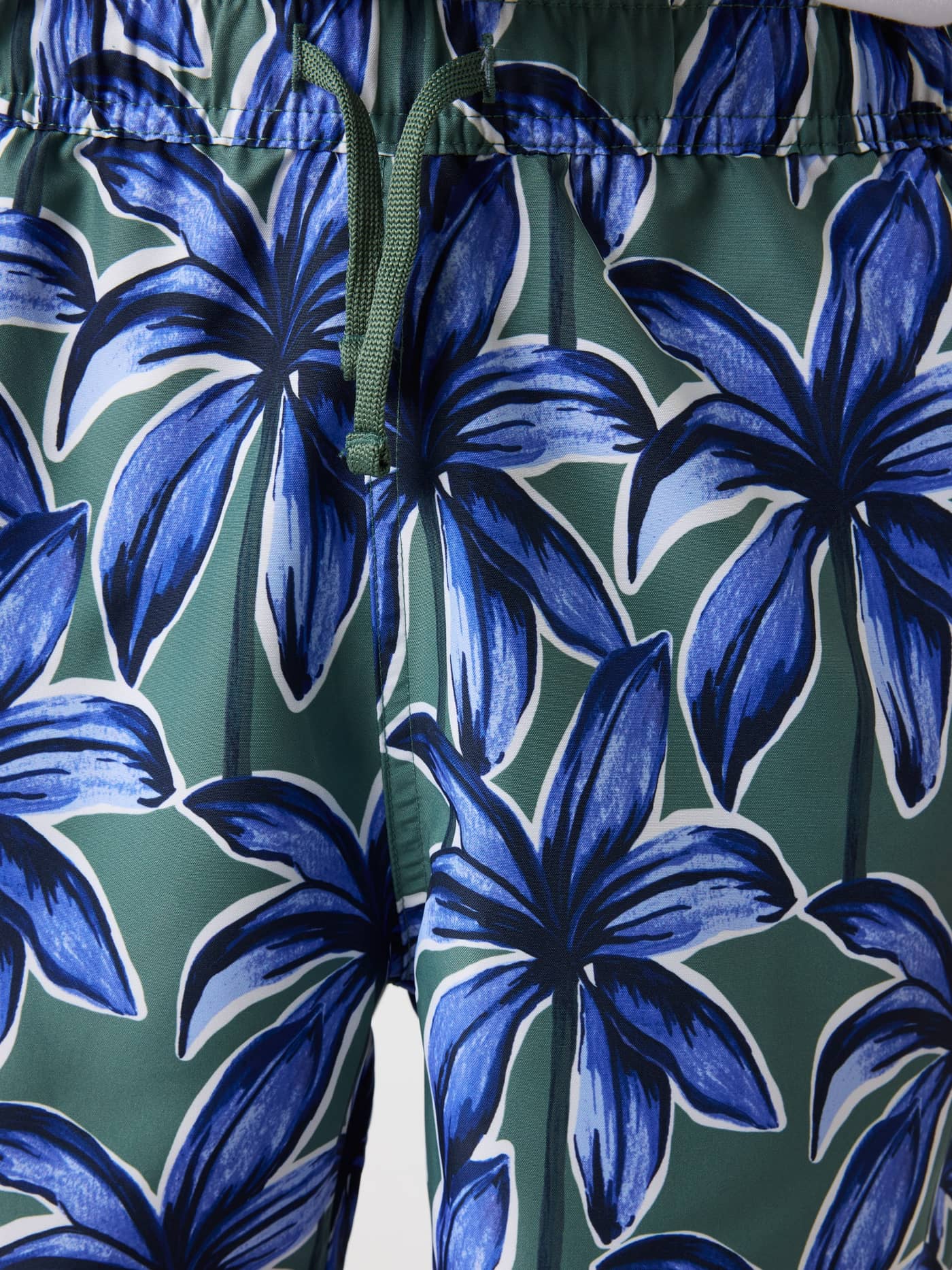Front view of kids’ Borg Print Swim Shorts in Palms On Palms 1 (Blue, Green) with an elastic waist and drawstring. - Image 5