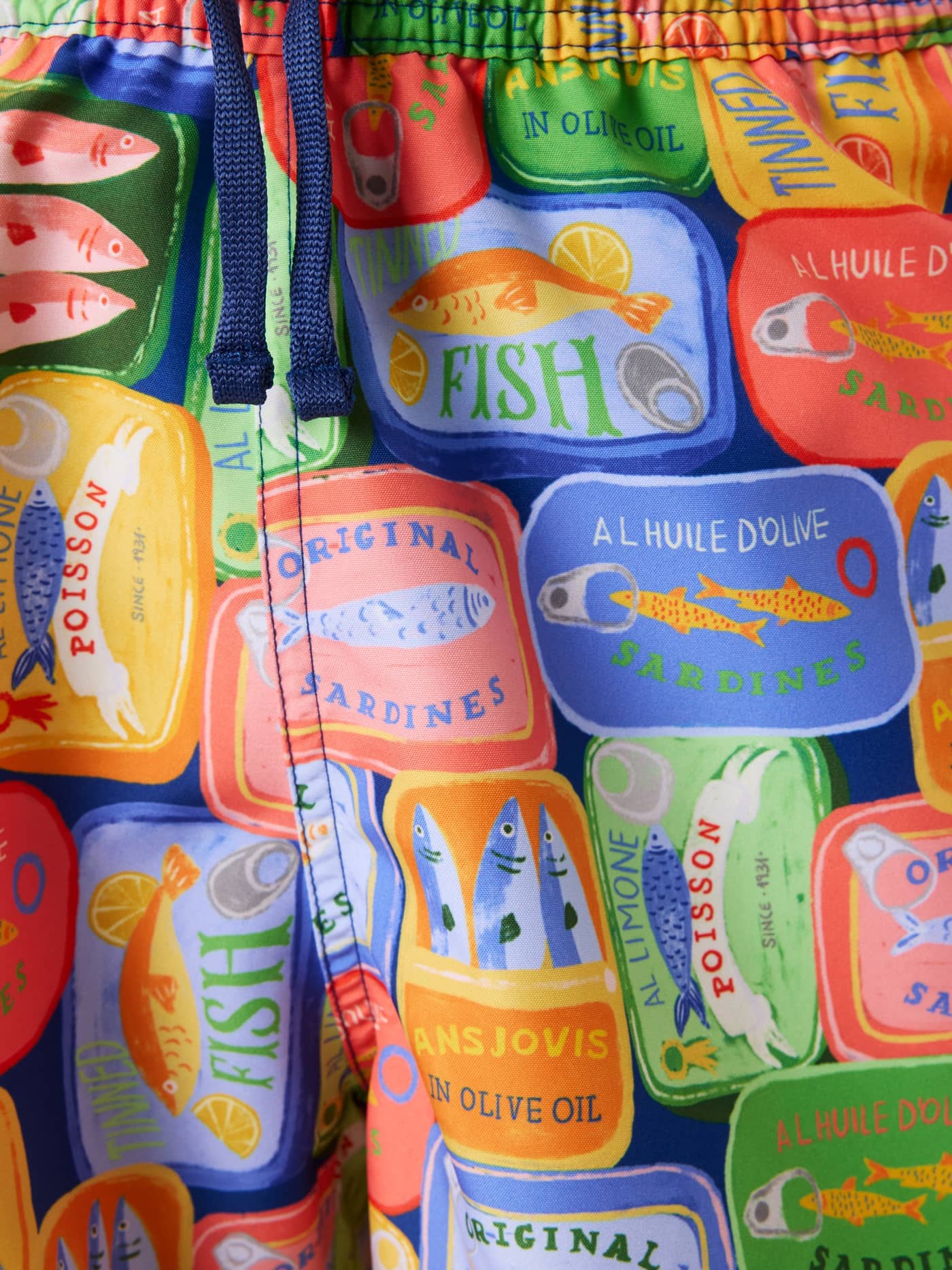 Close-up of the kids' Borg Print Swim Shorts in multi, featuring a vibrant blue, green, and yellow sardine tin print. - Image 5