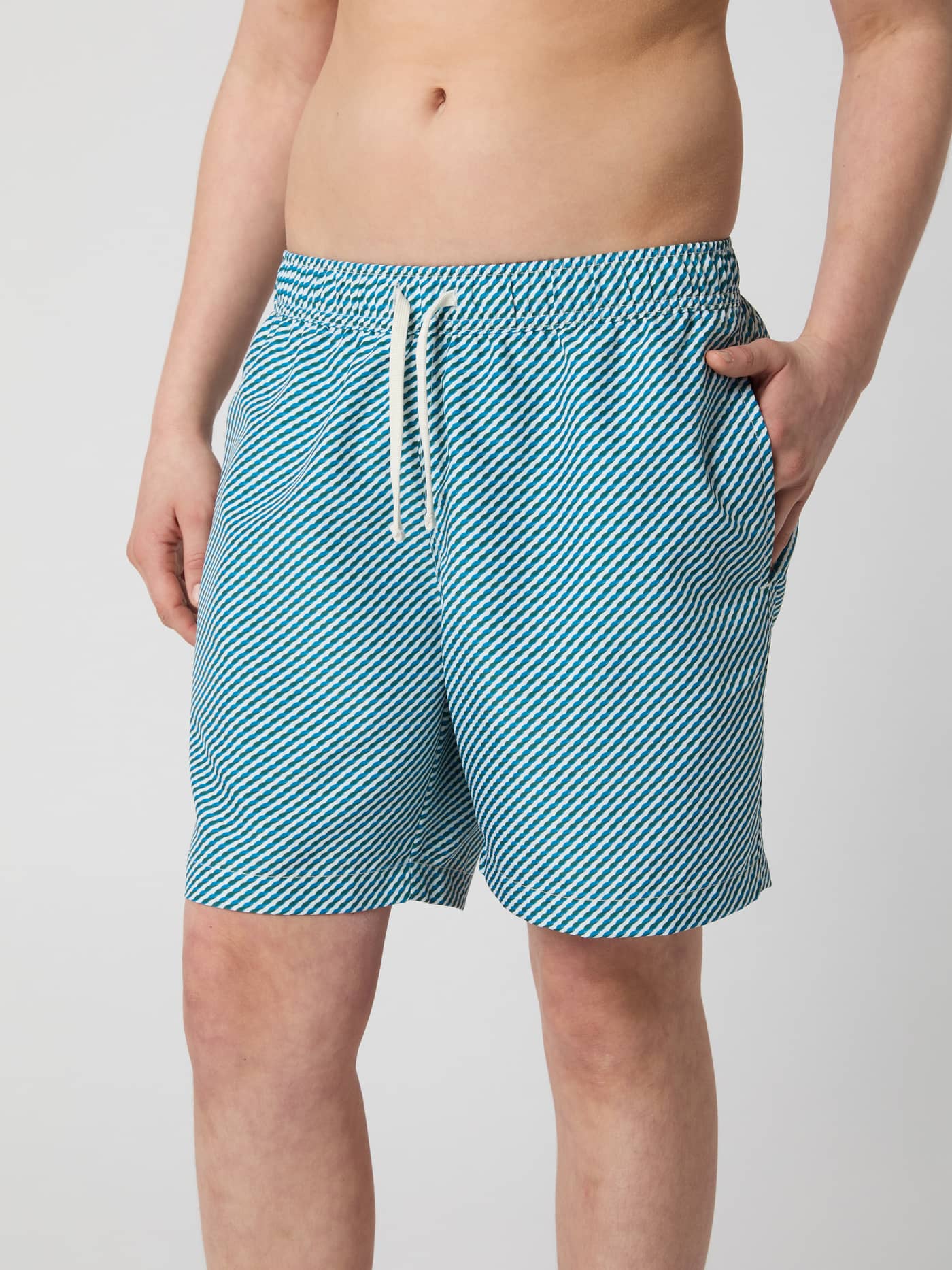 Front view of a model wearing kids' Borg Print Swim Shorts in Candy Stripe 2 (Blue) with a regular fit and striped pattern. - Image 2