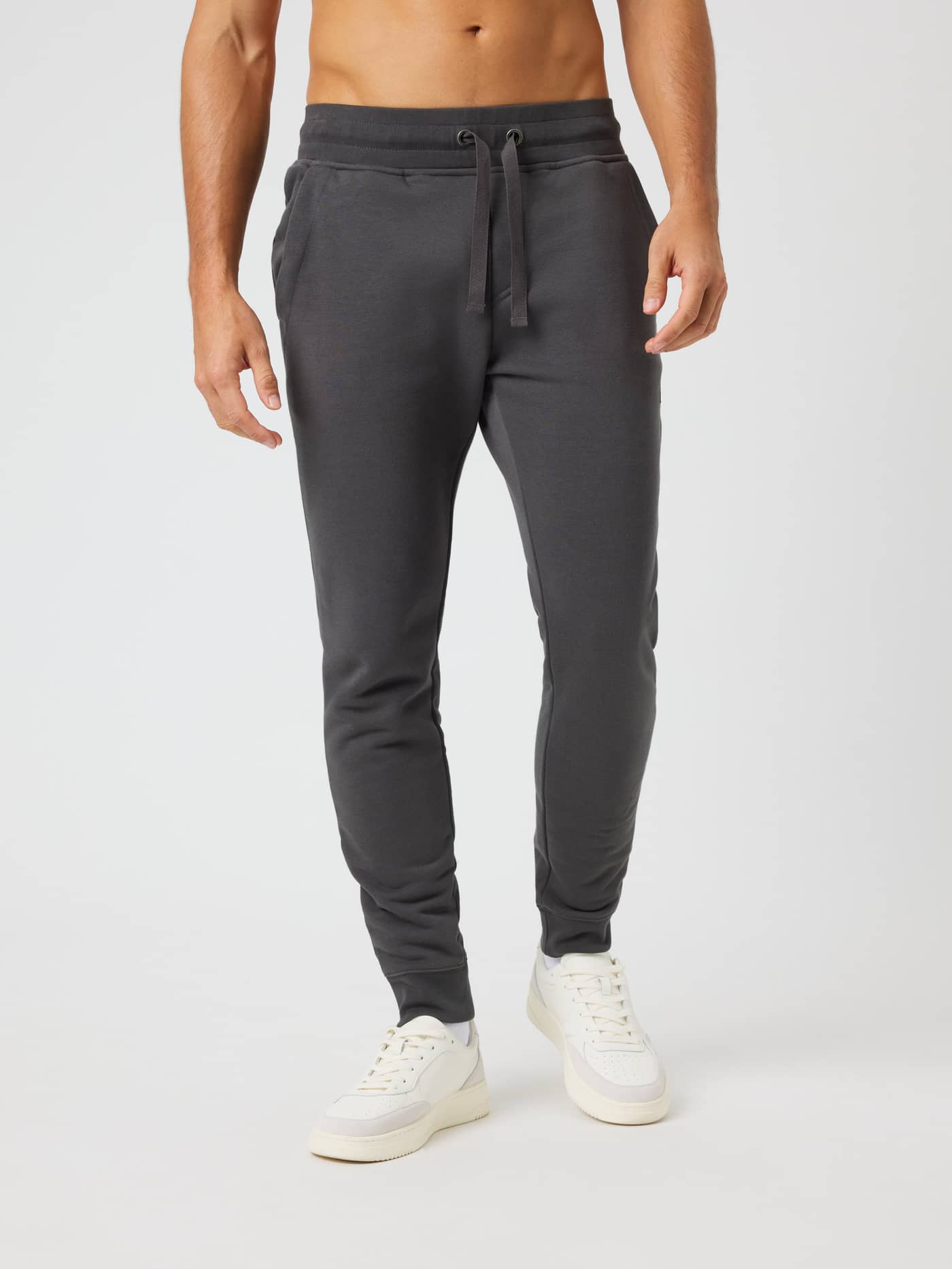 Vue de face d'un homme en Centre Tapered Sweatpants Asphalt (Gris) avec coupe ajustée et taille à cordon de serrage. - Image 1