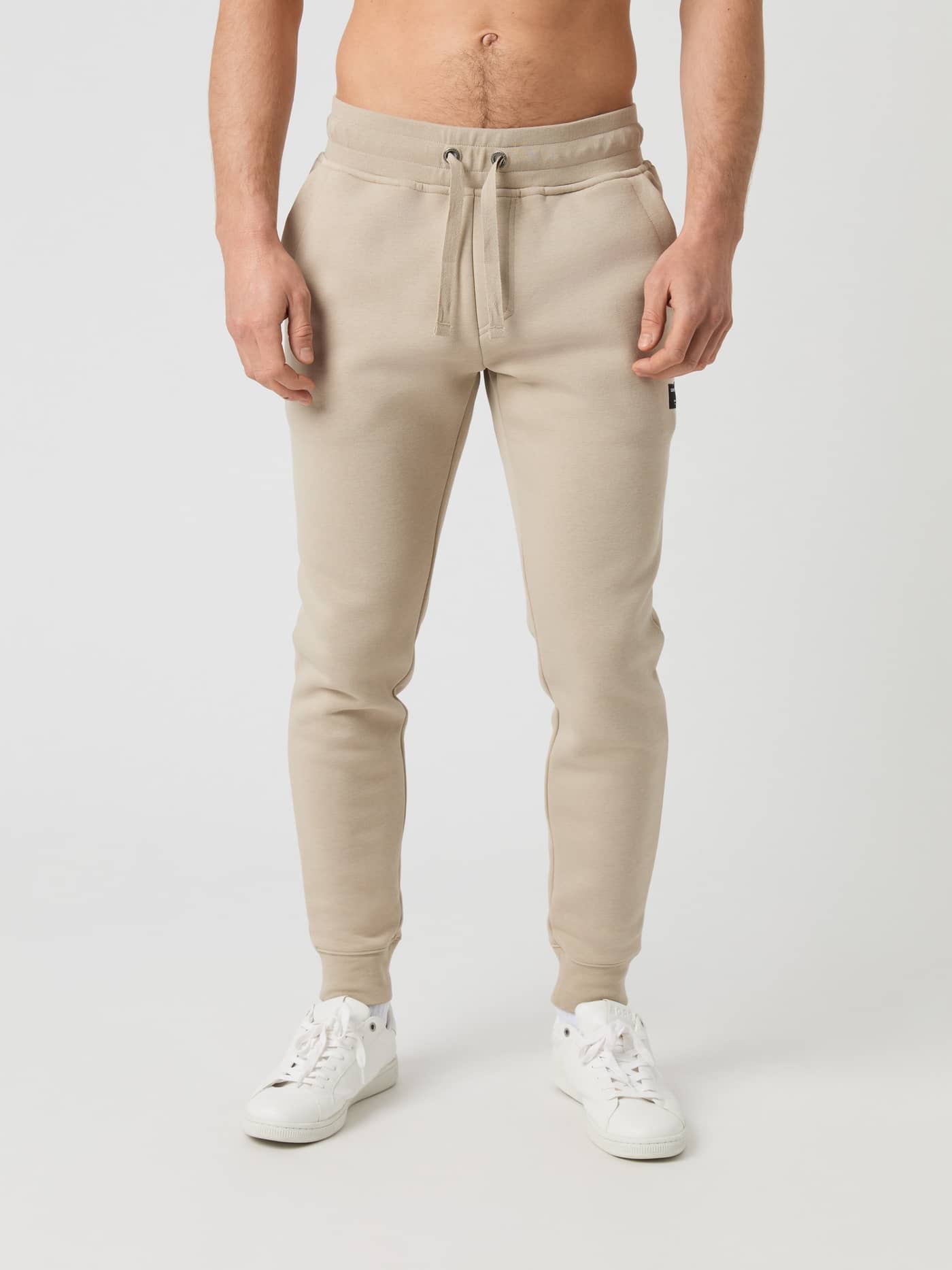 Front view of a model wearing Björn Borg Centre Tapered Sweatpants in beige. - Image 1