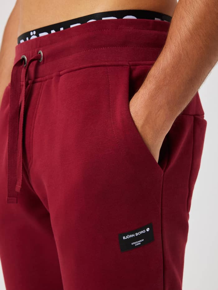Close-up of the Centre Tapered Sweatpants in Cabernet (Red) featuring an adjustable drawstring and side pockets.