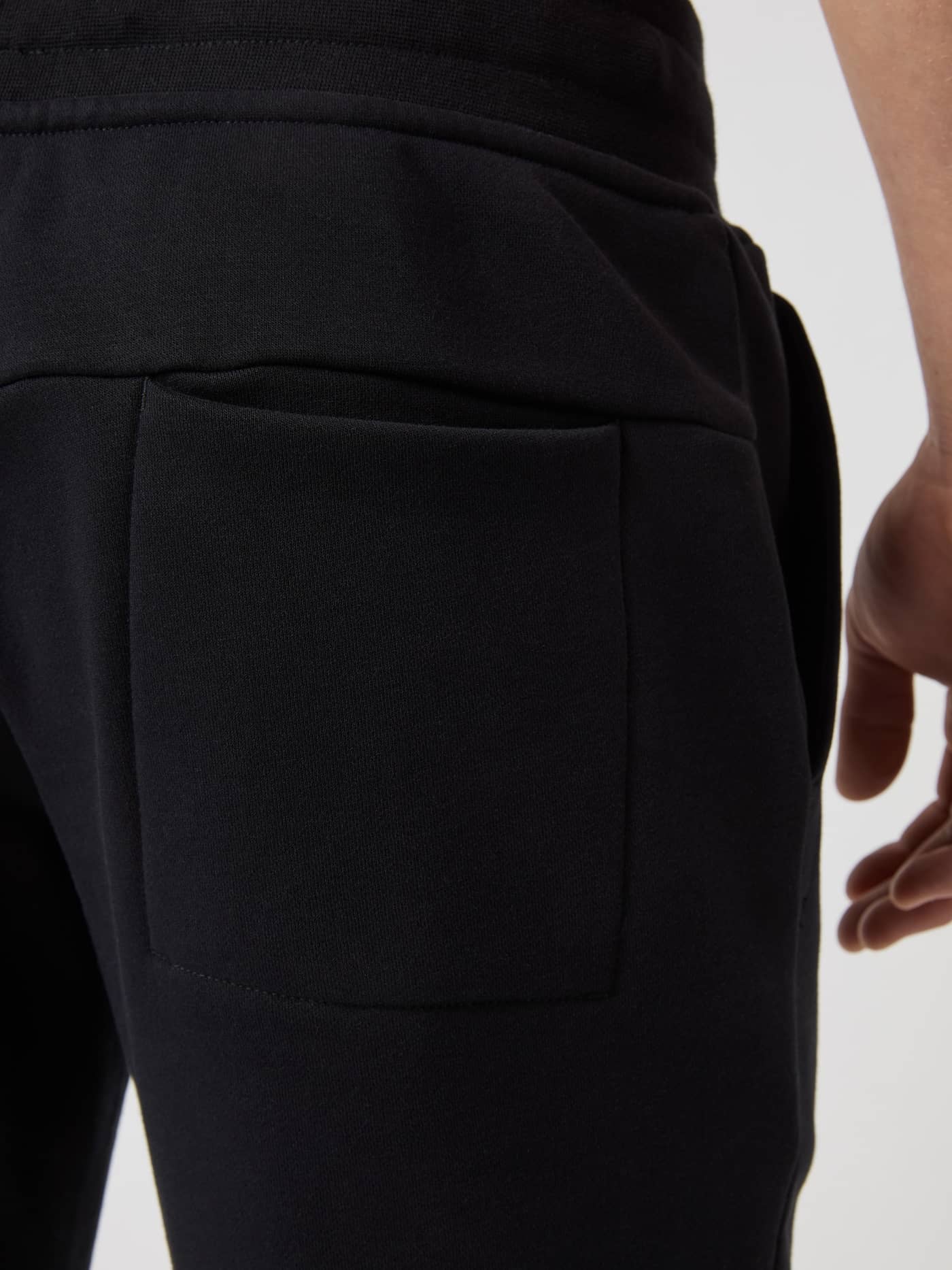 Close-up of the back pocket on the black Björn Borg Centre Tapered Sweatpants. - Image 3