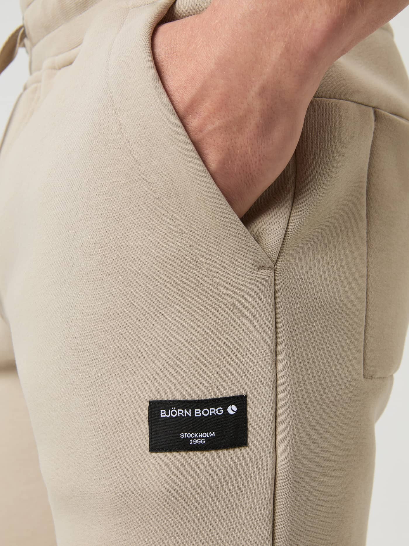 Close-up of the Björn Borg Centre Tapered Sweatpants in Pure Cashmere, showing the side pocket and black logo patch. - Image 5