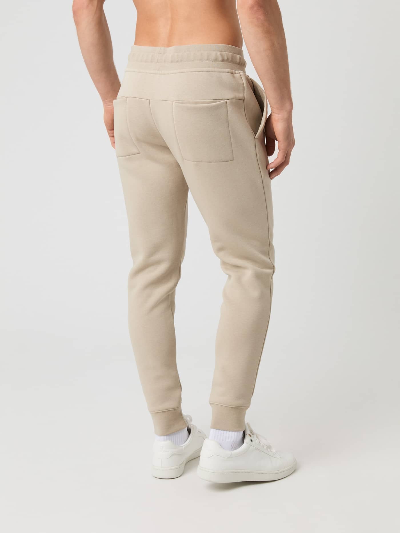 Back side view of a model wearing the Björn Borg Centre Tapered Sweatpants in Pure Cashmere. - Image 2