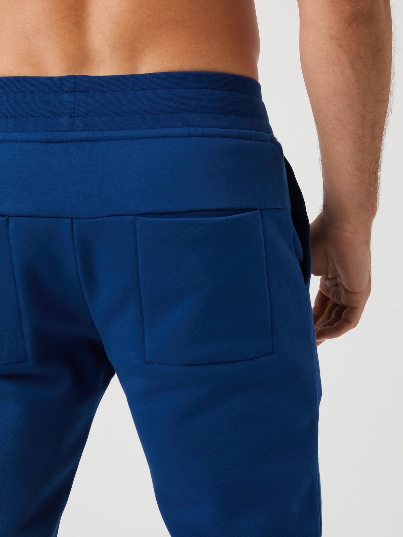 Close-up back view of the Björn Borg Centre Tapered Sweatpants in Estate Blue, showing the back pocket detail. - Image 3