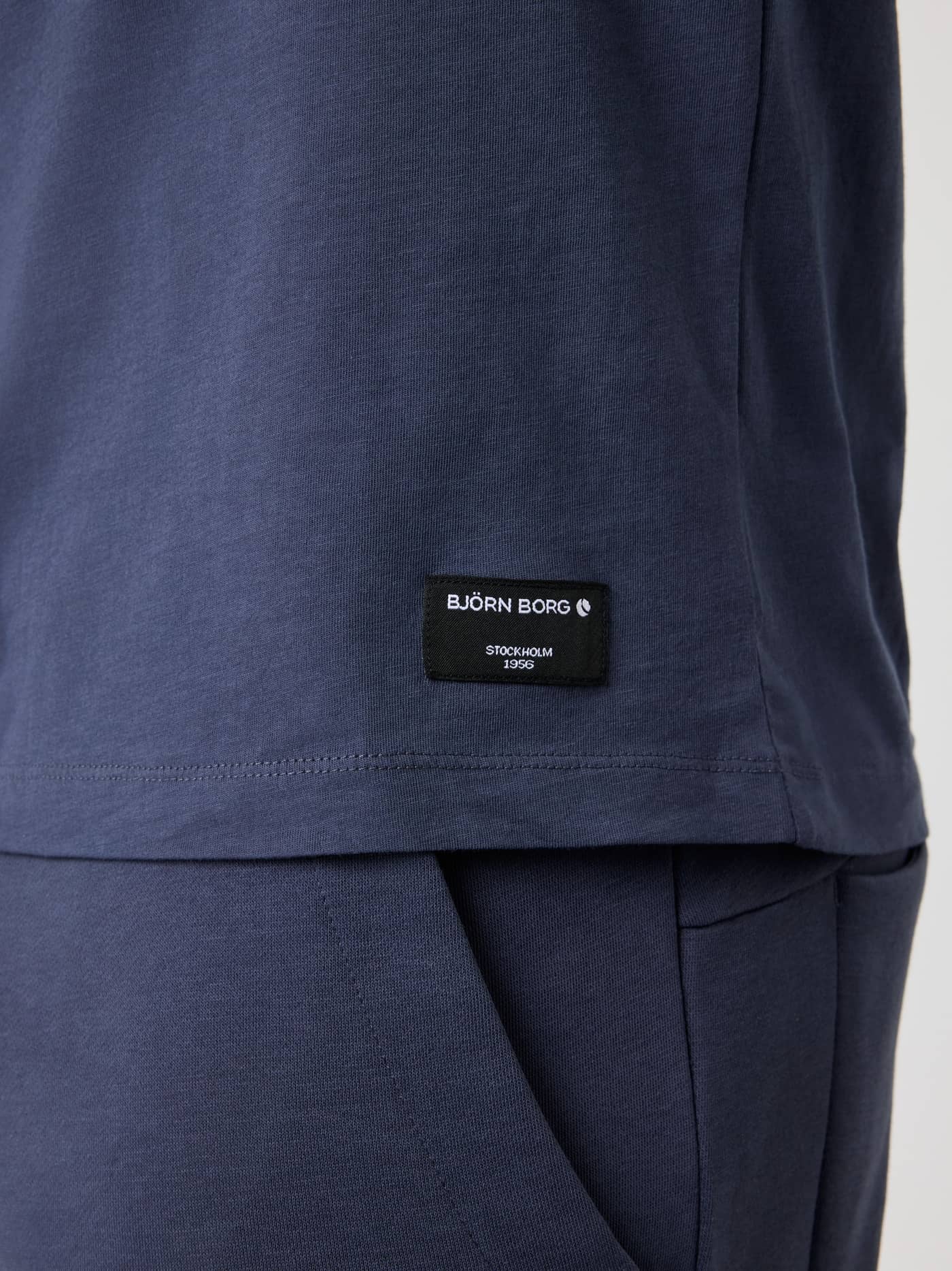 Detailed close-up of the black logo label on the Odyssey Gray (Grey) Centre T-Shirt in soft cotton jersey. - Image 4