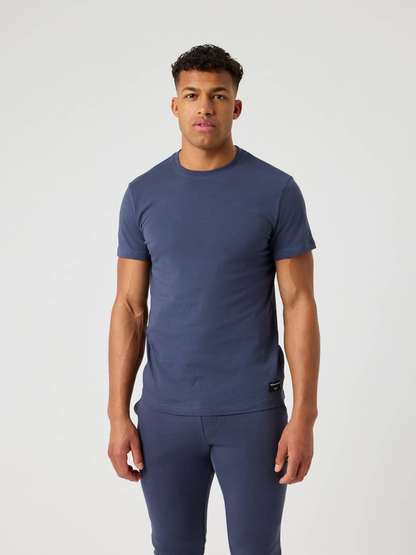 Front view of a man wearing the Björn Borg Centre T-Shirt in Odyssey Gray (Grey), made from soft 100% cotton. - Image 1