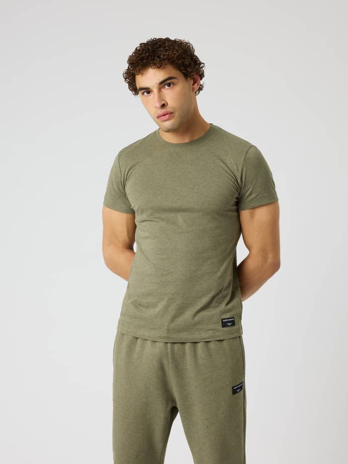 Front view of a man wearing the regular fit Centre T-Shirt in Winter Moss Melange (Green) with a black Borg label.