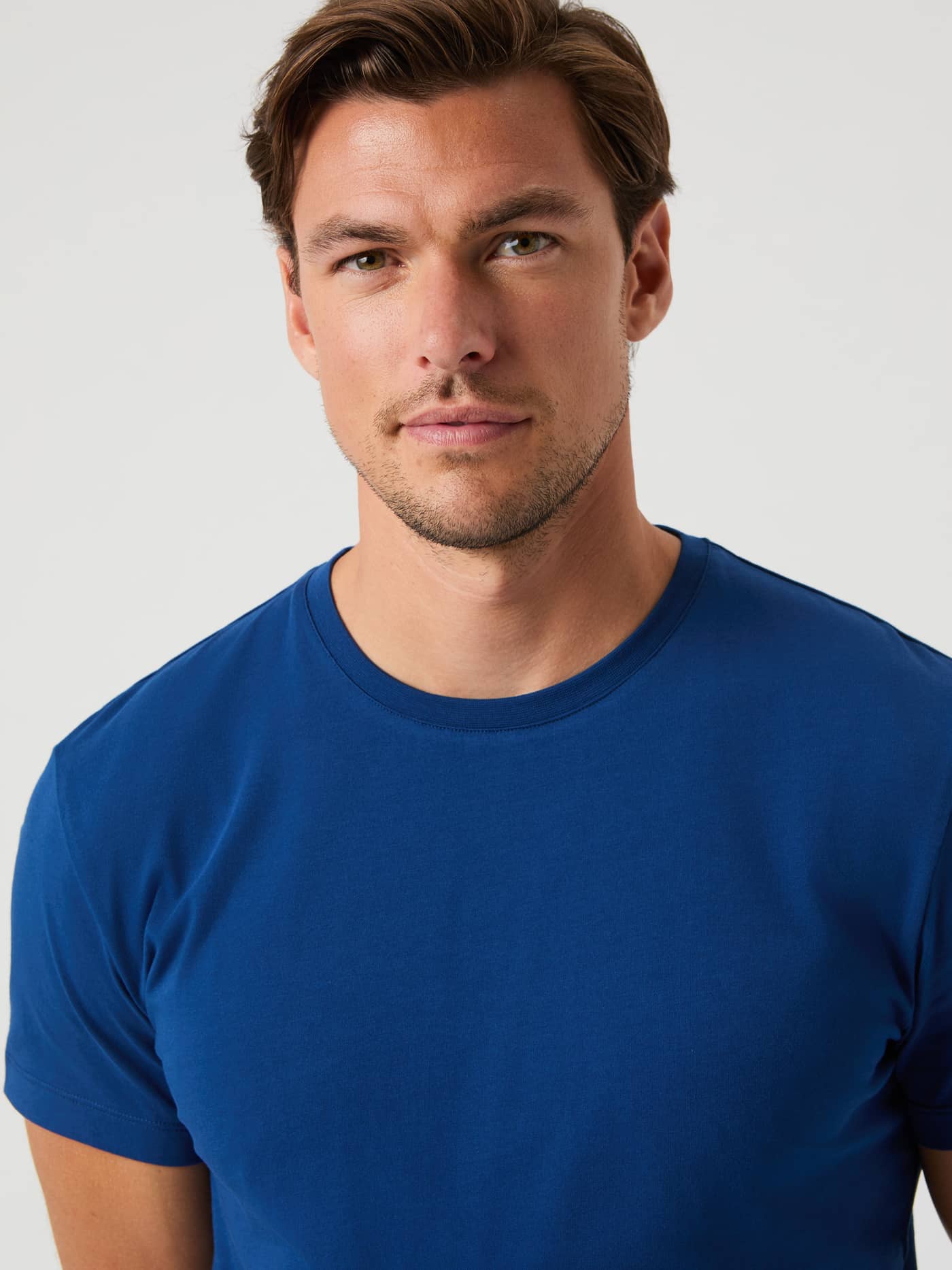 Close-up of a male model wearing the Björn Borg Centre T-Shirt in Estate Blue. - Image 5