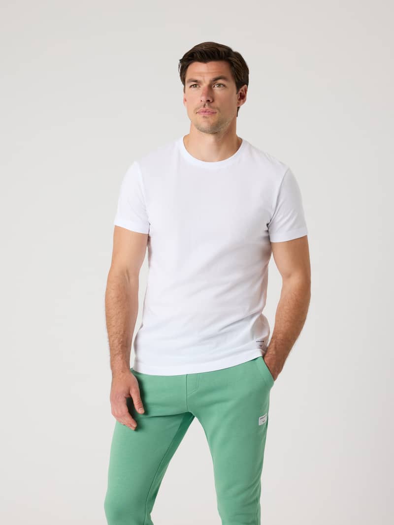 Front view of a man wearing the Björn Borg Centre T-Shirt in Brilliant White (White), made from soft cotton jersey.