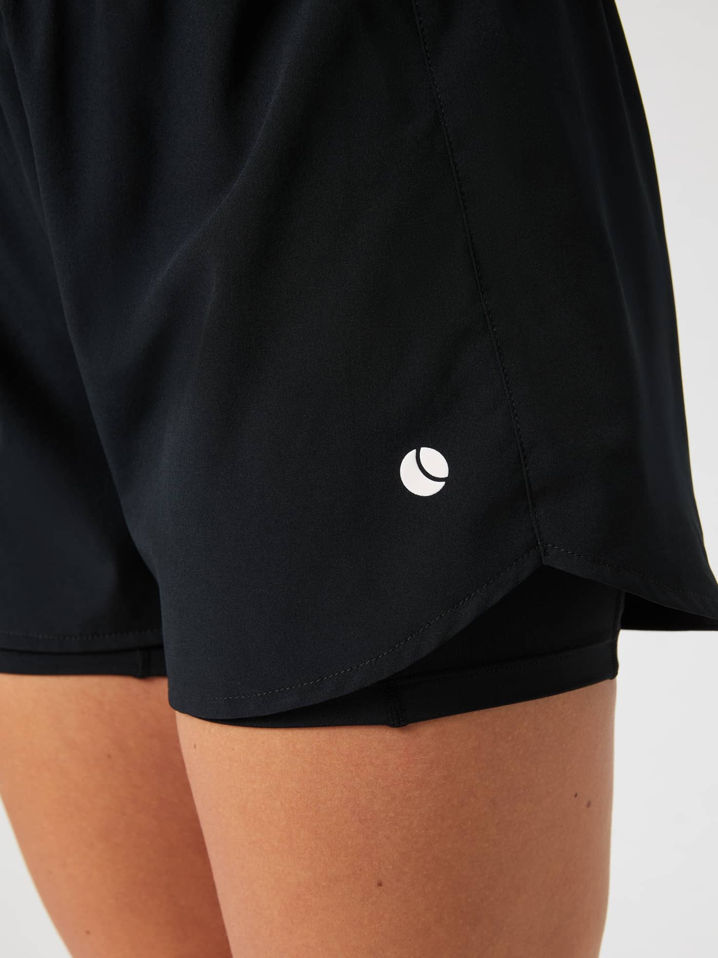 Close-up of the black Björn Borg Ace 2 in 1 Shorts, showing the inner shorts layer and tennis ball logo. - Image 5