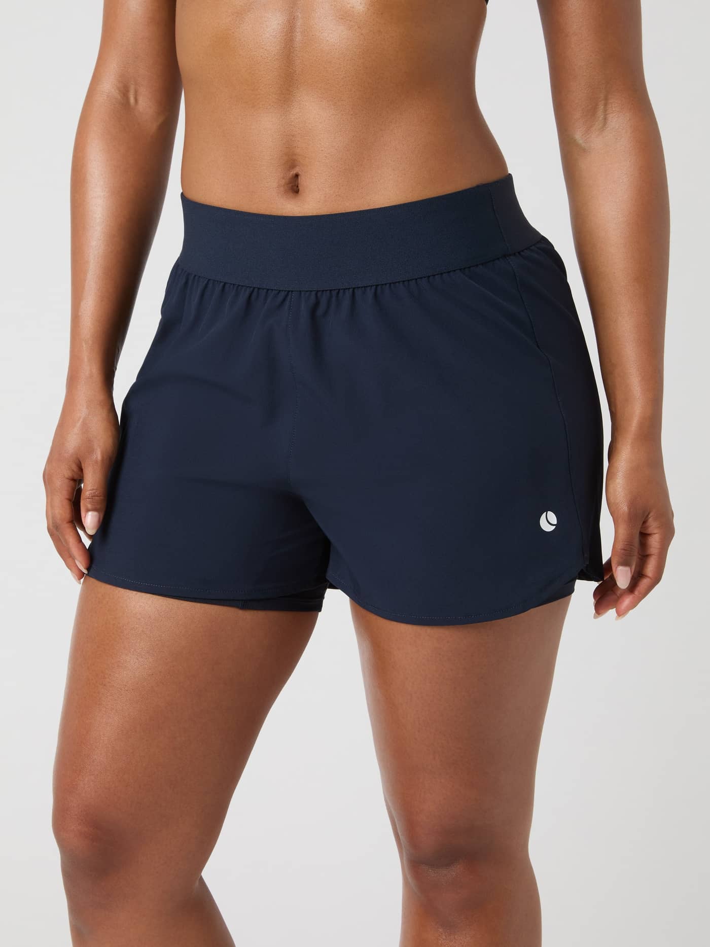 Front view of a woman wearing the Björn Borg Ace 2 In 1 Shorts in dark navy. - Image 2