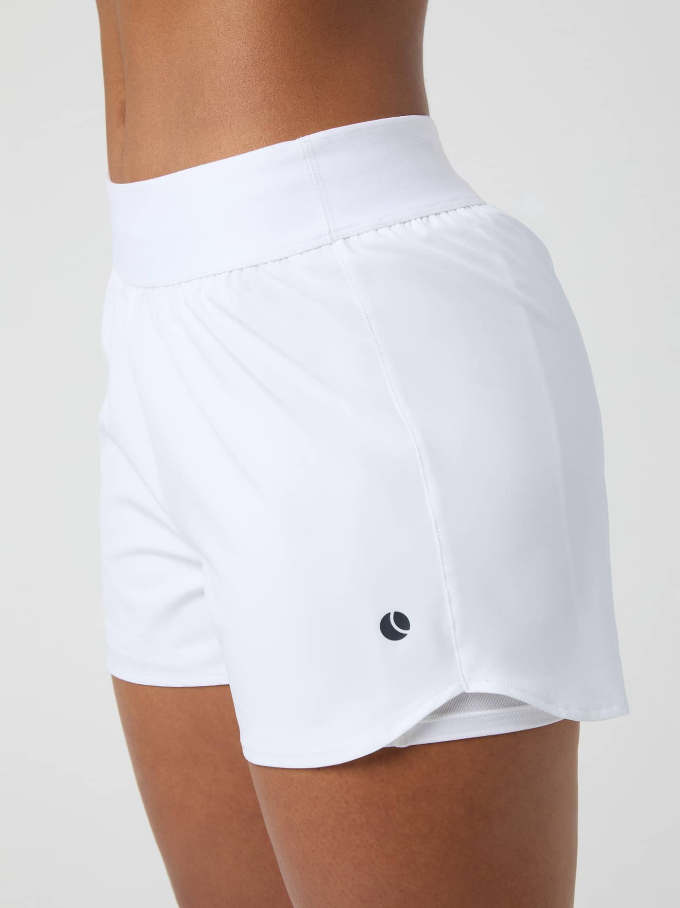 Detailed side view of the Björn Borg Ace 2 in 1 Shorts in brilliant white, highlighting the fit and wide waistband. - Image 3