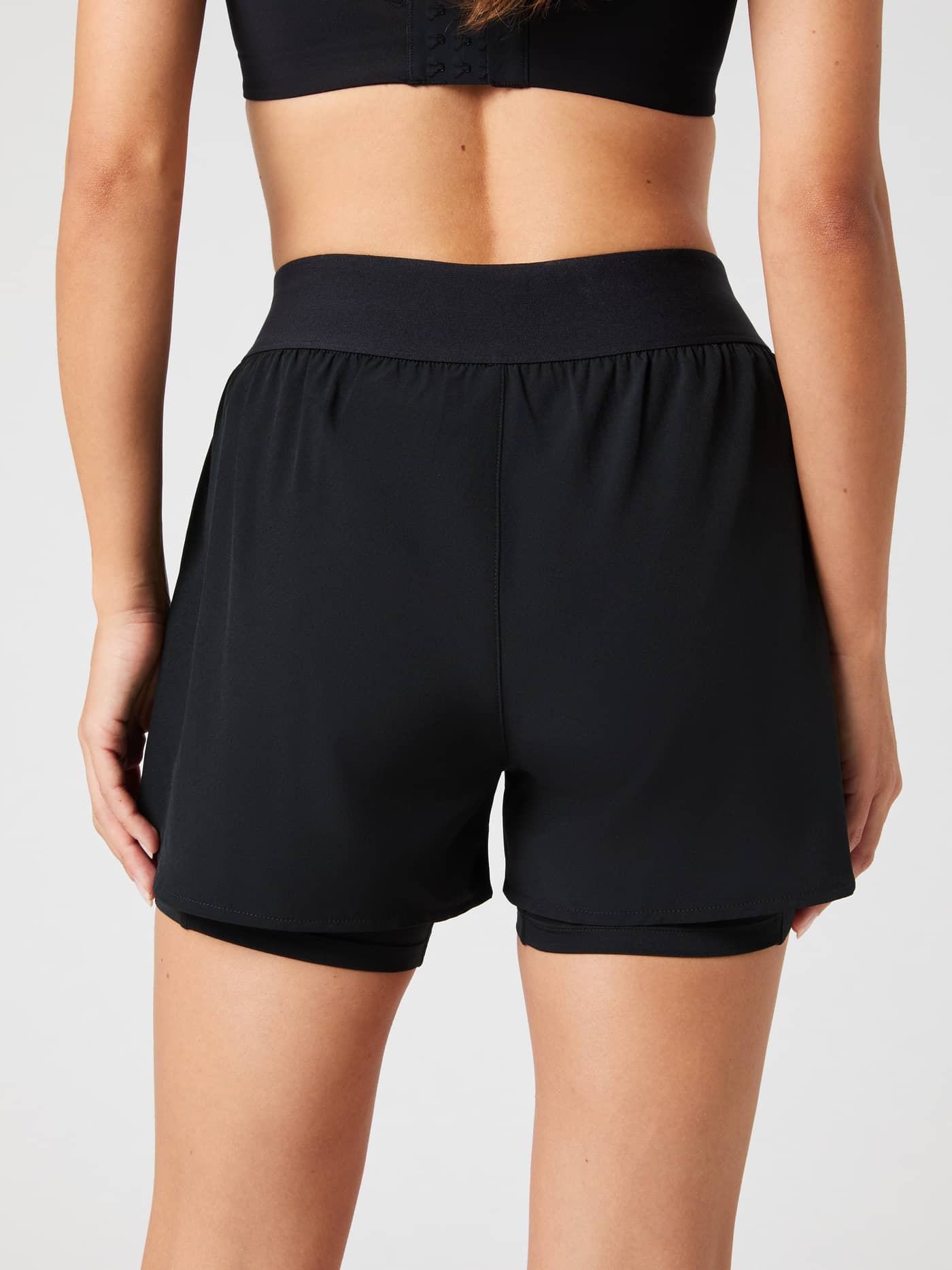 Back view of a model wearing the black Björn Borg Ace 2 in 1 Shorts. - Image 3