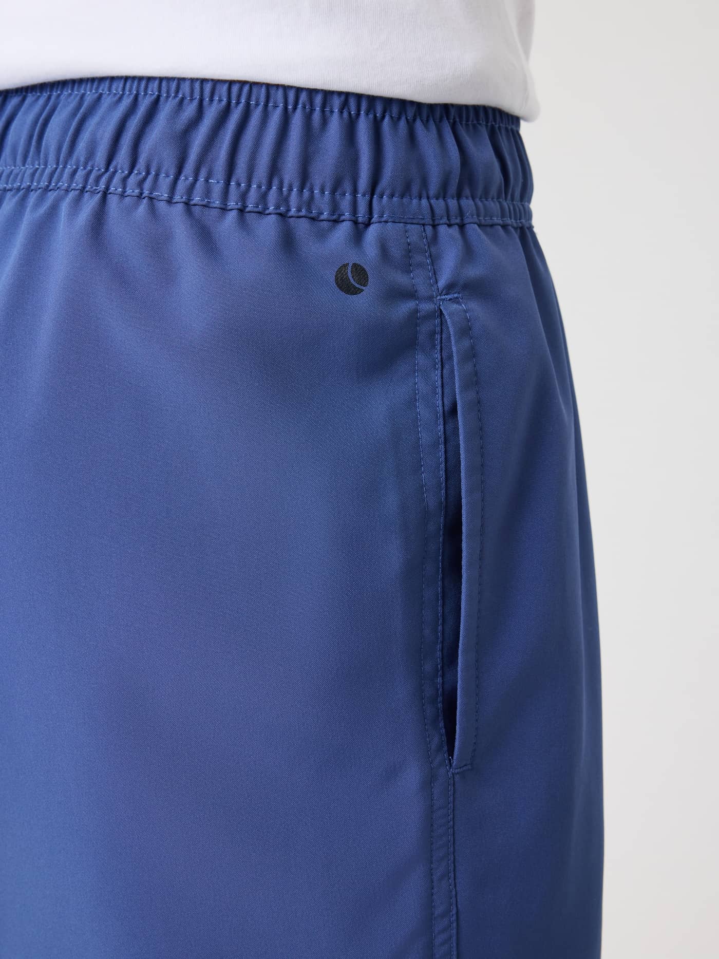 Detailed close-up of the kids’ Borg Swim Shorts in Coastal Fjord (Blue), featuring a side pocket and small black logo. - Image 4