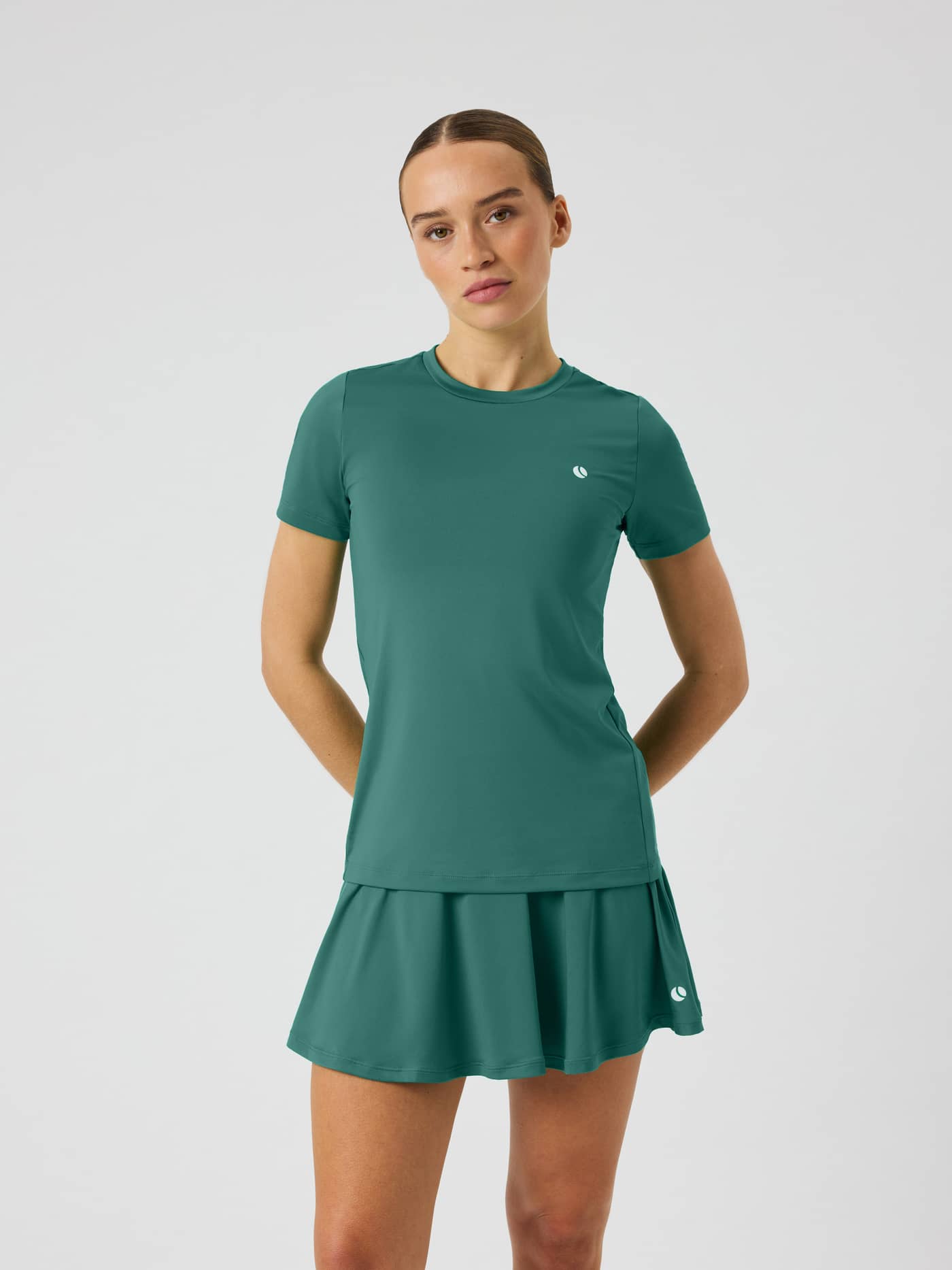 Ace Slim T-Shirt in Mallard Green (Green) with a white tennis ball logo, shown in a front view on a model for training. - Image 2