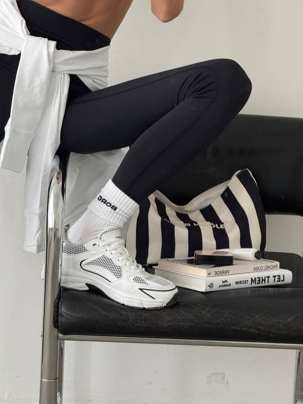 Borg Beach Wash Bag en Black Beauty (Noir) à rayures, trousse de toilette lifestyle avec logo noir et baskets.