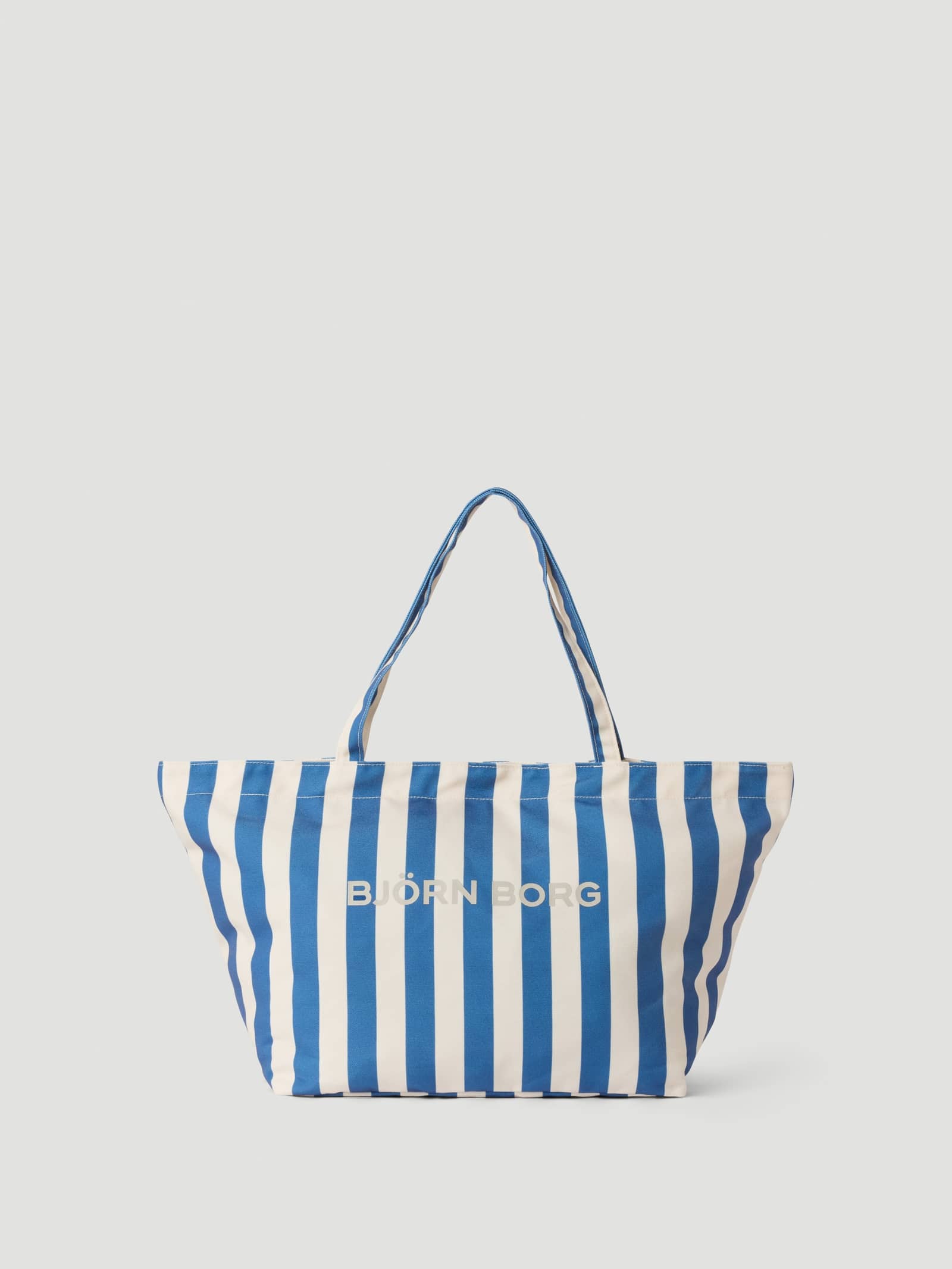 Front view of the Borg Beach Tote M - 27L in Coastal Fjord (Blue) with blue and white stripes and a beige logo. - Image 1